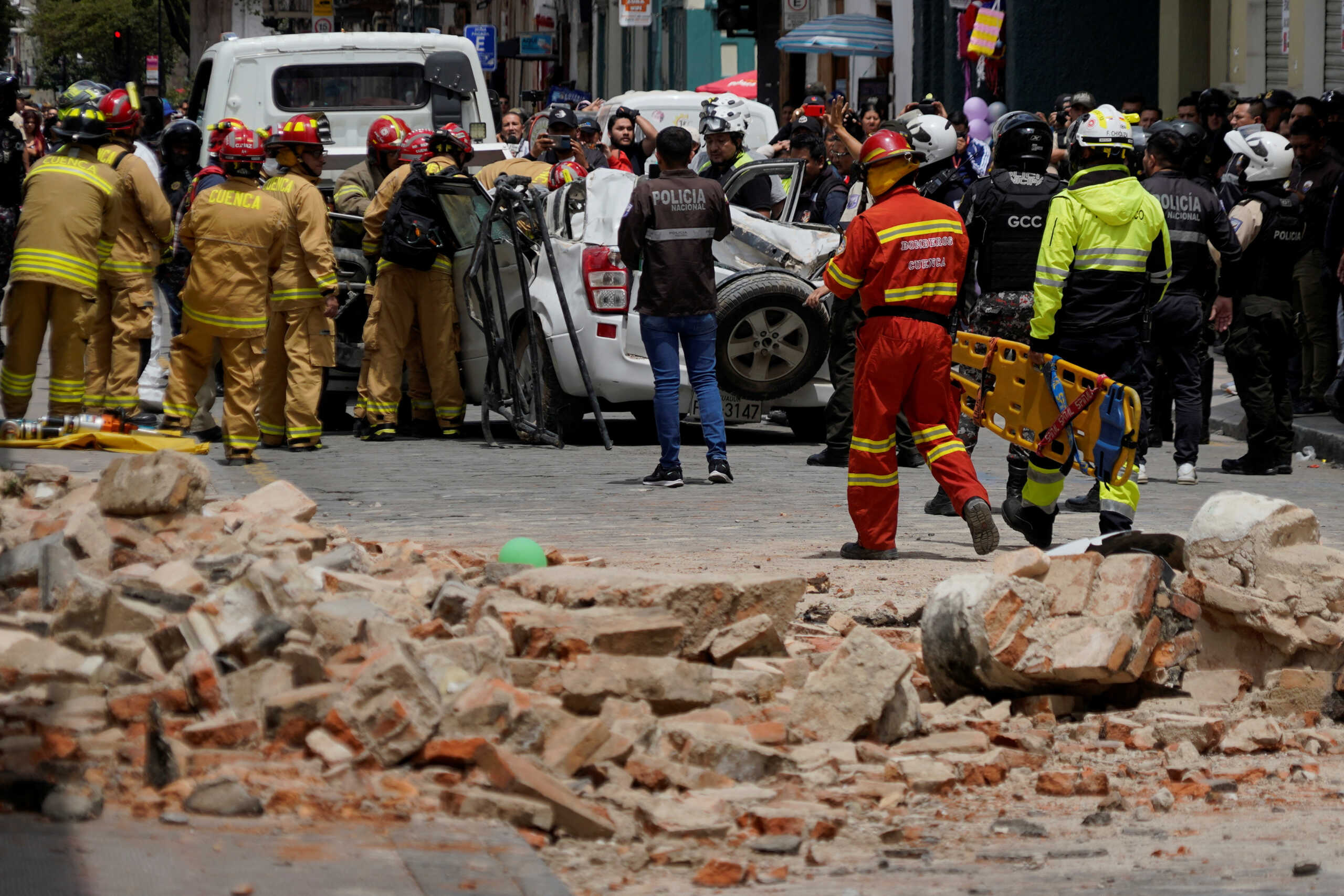 A damaged car and rubble from a house affected by the earthquake are pictured in Cuenca, Ecuador. March 18, 2023. REUTERS