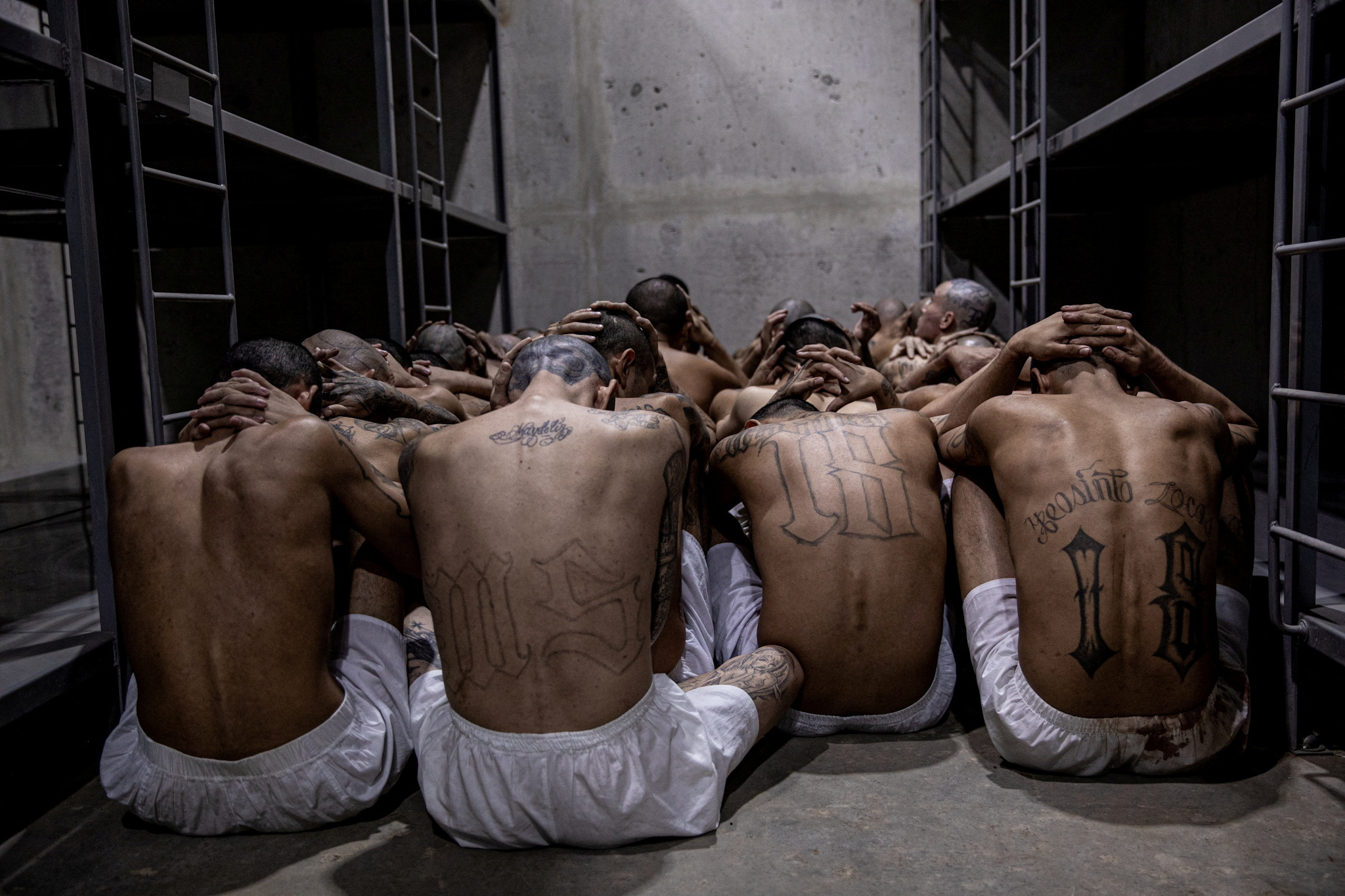 Gang members wait to be taken to their cell after 2000 gang members were transferred to the Terrorism Confinement Center, according to El Salvador's President Nayib Bukele, in Tecoluca, El Salvador, in this handout distributed to Reuters on March 15, 2023. Secretaria de Prensa de la Presidencia