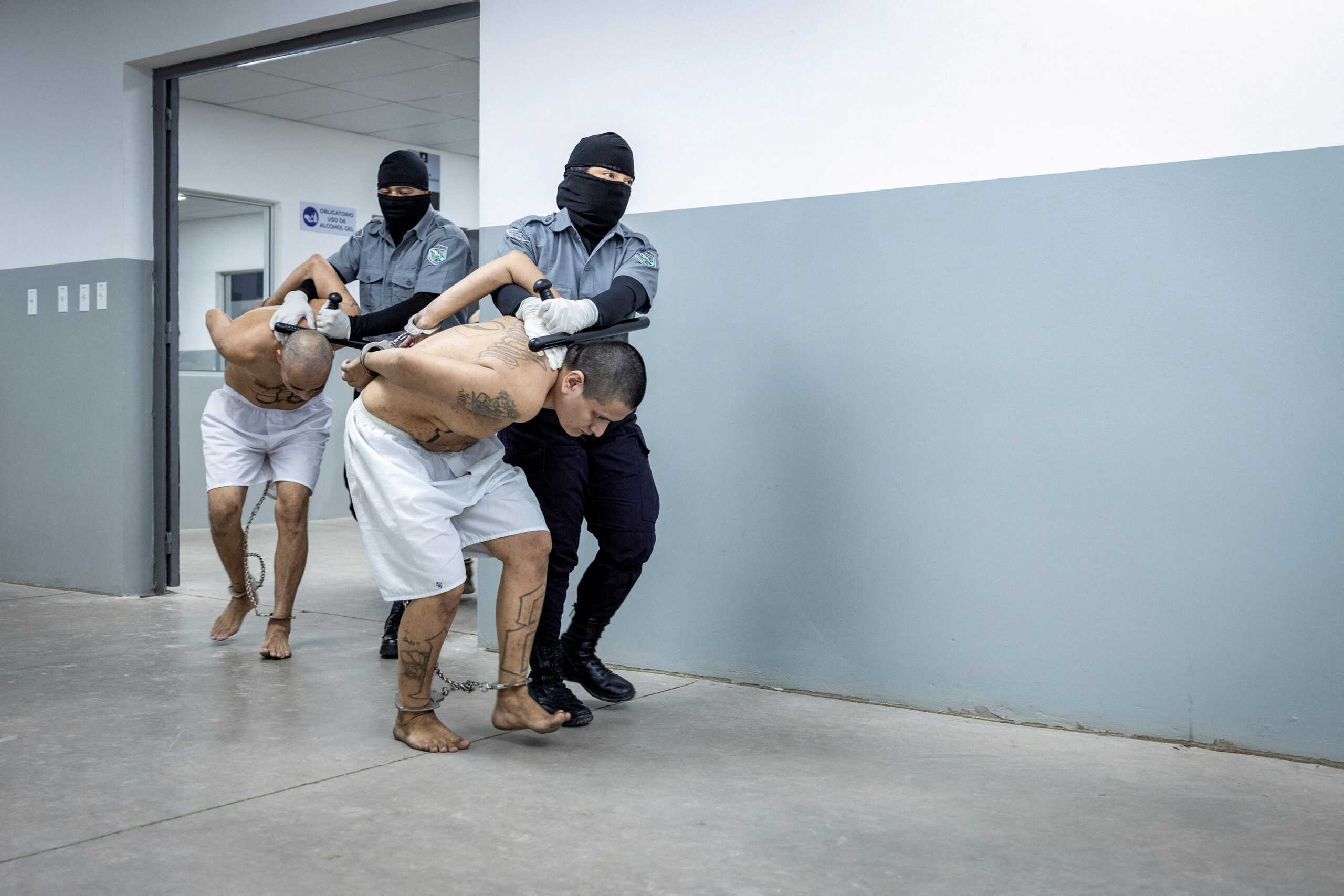 Prison agents guard gang members as they are processed after 2000 gang members were transferred to the Terrorism Confinement Center, according to El Salvador's President Nayib Bukele, in Tecoluca, El Salvador, in this handout distributed to Reuters on March 15, 2023. Secretaria de Prensa de la Presidencia