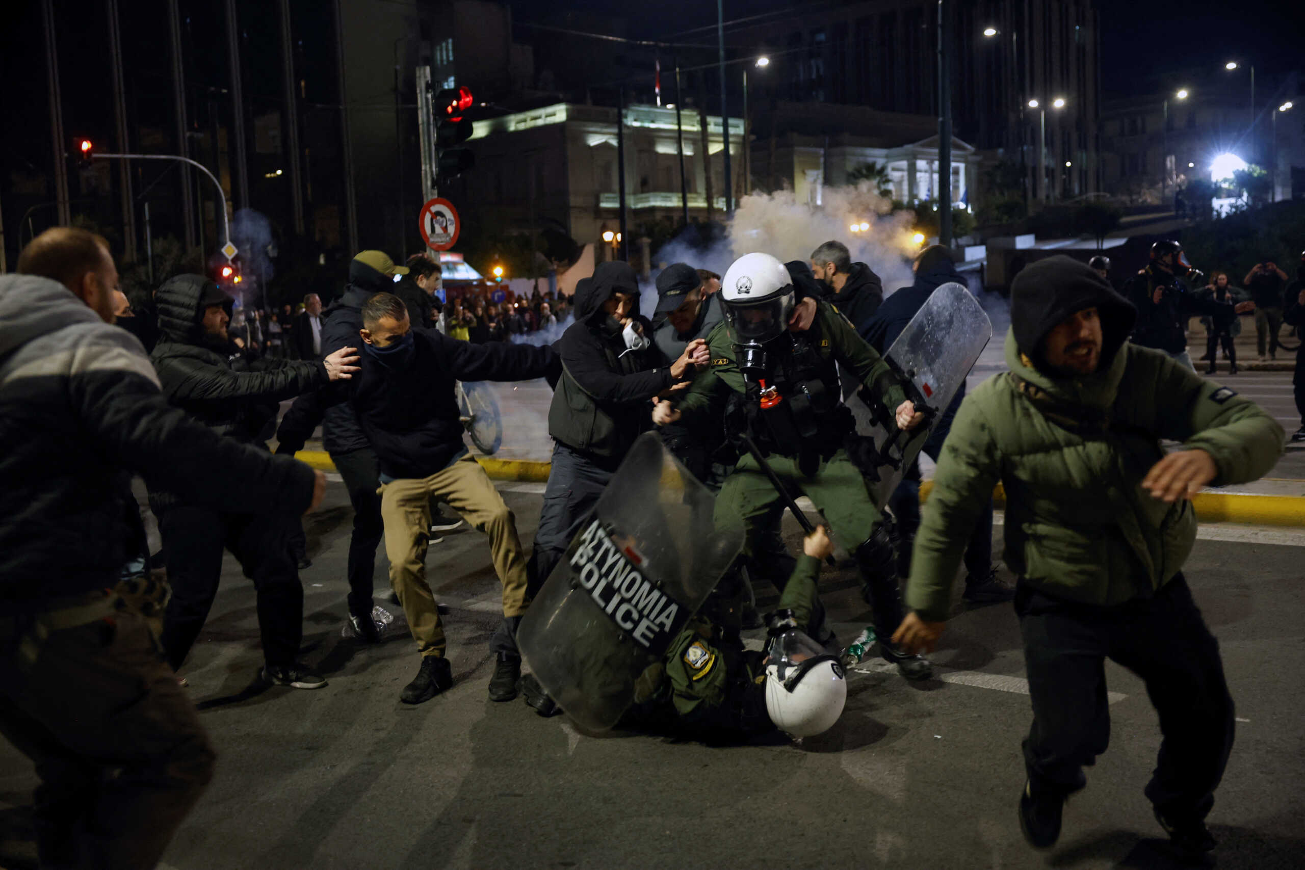 Protesters attack riot police officers as clashes take place during a demonstration in front of the parliament building following the collision of two trains, near the city of Larissa, in Athens, Greece, March 3, 2023. REUTERS