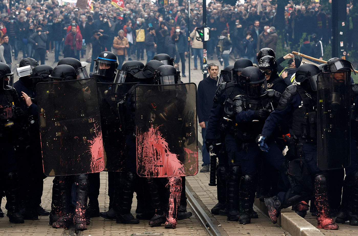Protesters face off with French CRS riot police amid clashes during a demonstration as part of the ninth day of nationwide strikes and protests against French government's pension reform, in Nantes, France, March 23, 2023.  REUTERS