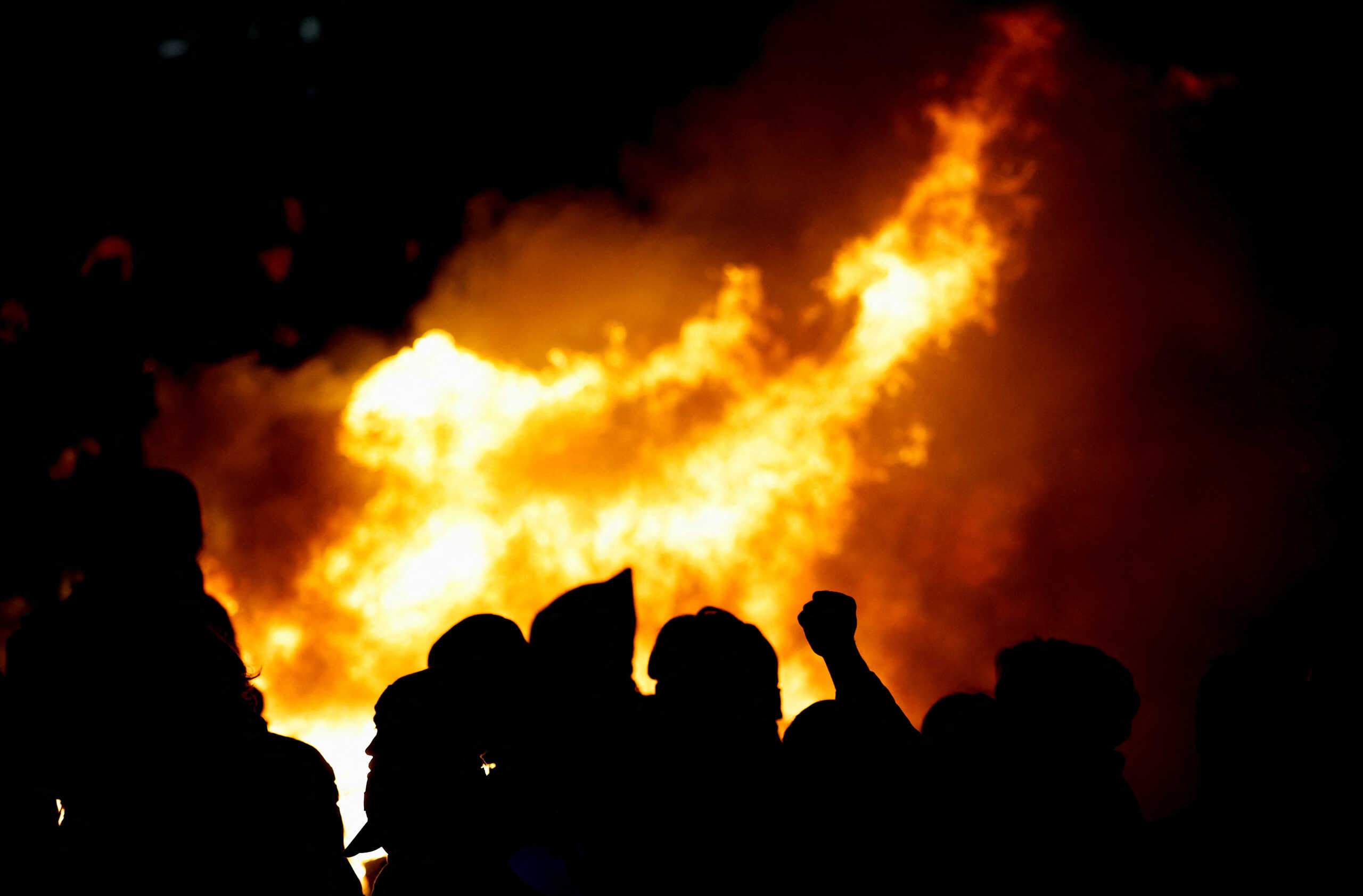Fire emerges as people attend a demonstration on Place de la Concorde to protest the use by French government of the article 49.3, a special clause in the French Constitution, to push the pensions reform bill through the National Assembly without a vote by lawmakers, in Paris, France, March 17, 2023. REUTERS