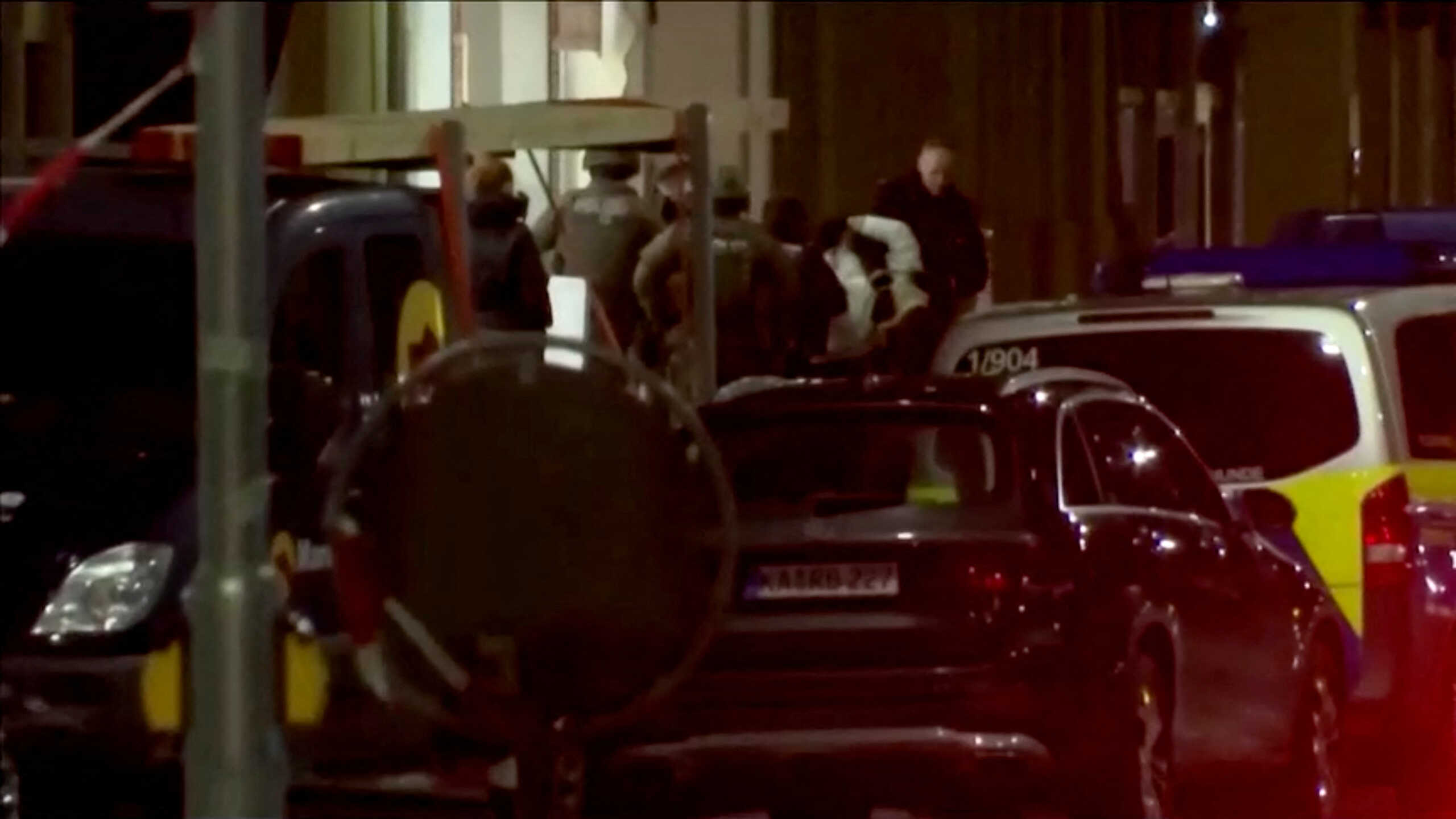 Police bring a detained person out of the site of a hostage situation inside a pharmacy in Karlsruhe, Germany March 10, 2023 in this screen grab from video. Reuters TV