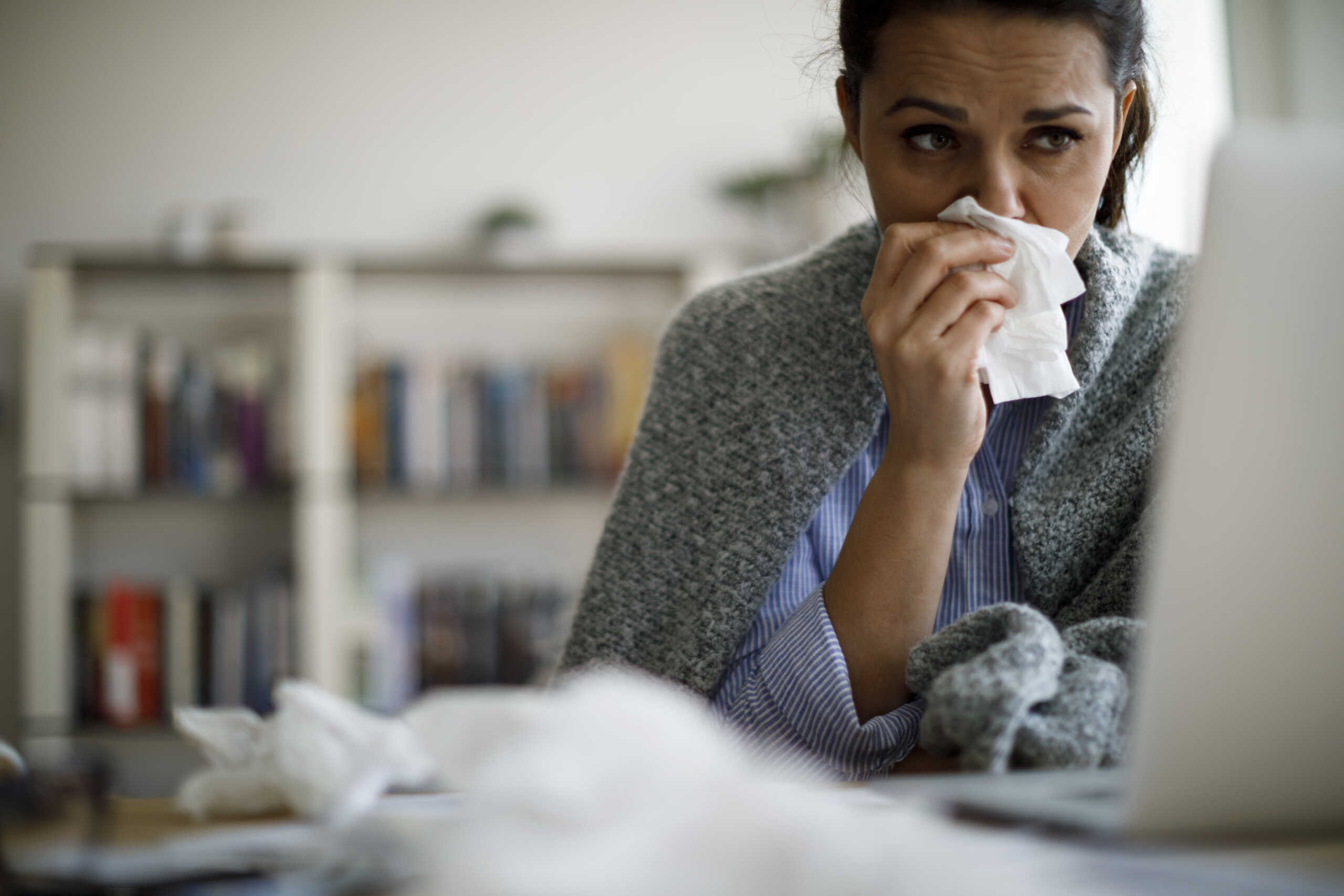 Woman blowing her nose