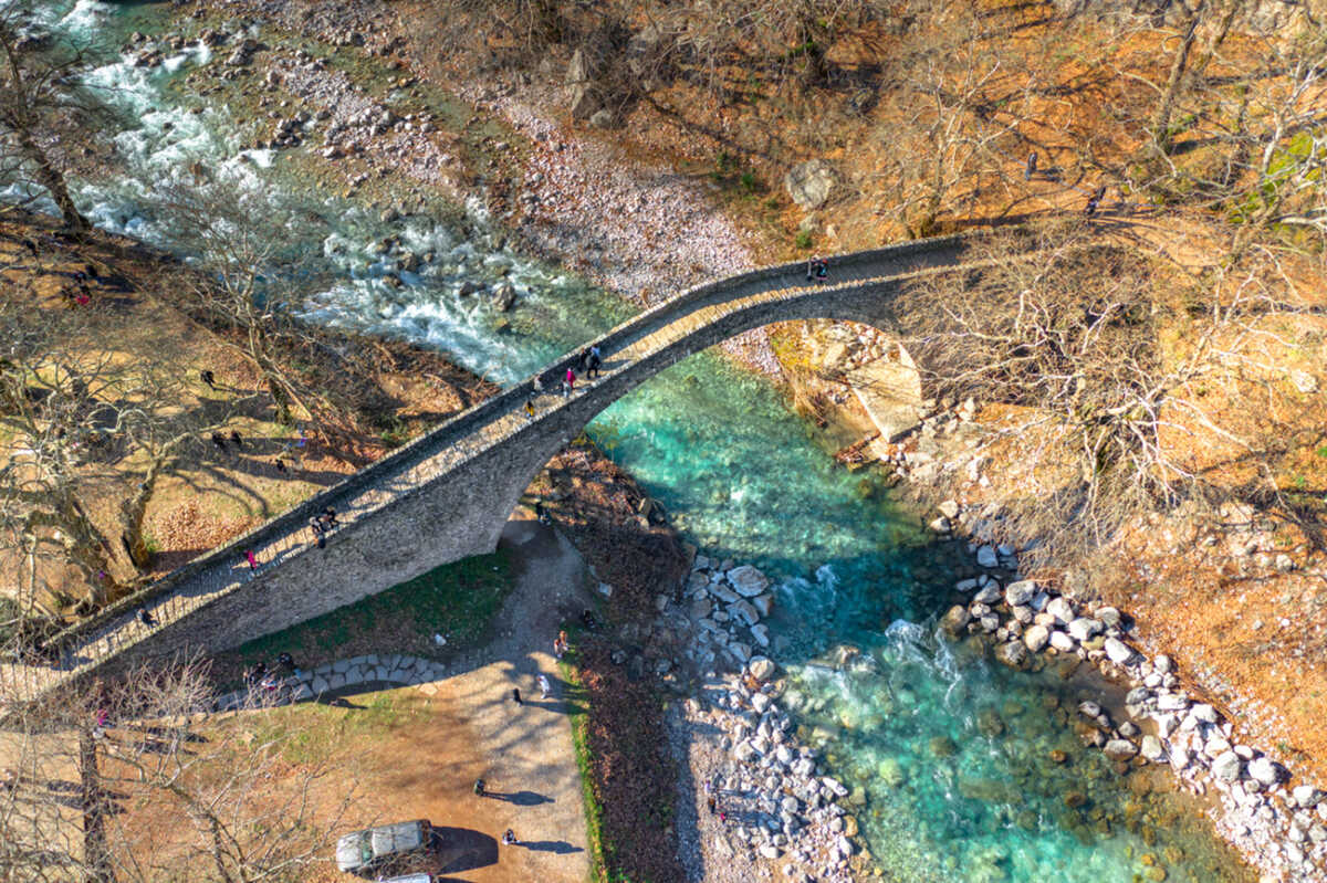 The Bridge of Agios Vissarionas in Pili Trikalon, Greece. The bridge was built in 1514 and lies amidst a remarkable landscape between the large masses of Aspropotamos and Agrafa mountain chains.