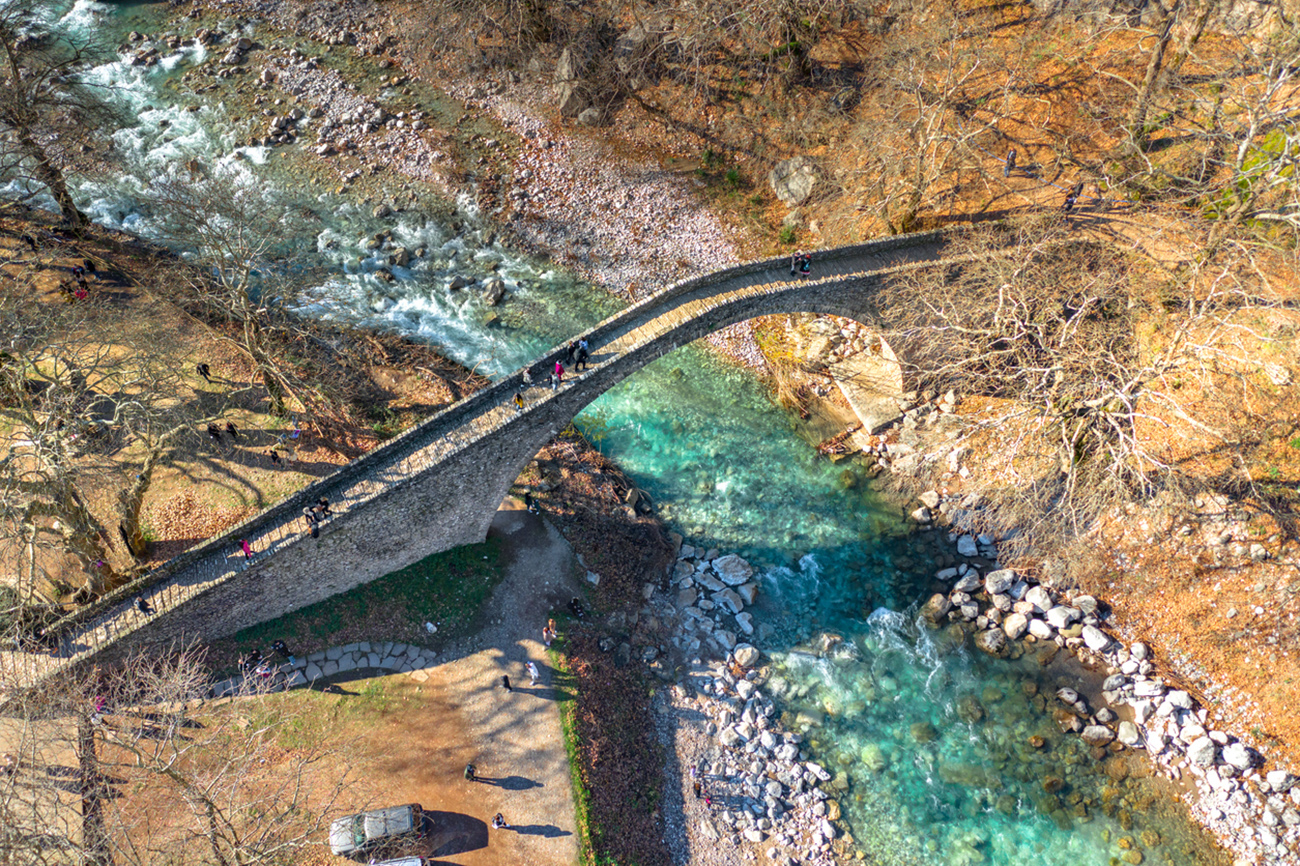 The Bridge of Agios Vissarionas in Pili Trikalon, Greece. The bridge was built in 1514 and lies amidst a remarkable landscape between the large masses of Aspropotamos and Agrafa mountain chains.