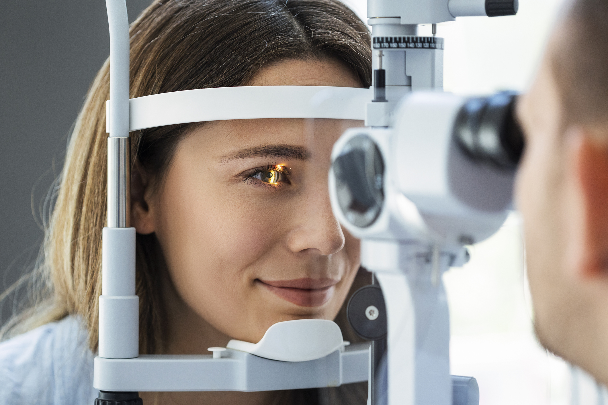 Beautiful young girl checking the eye vision in modern ophthalmology clinic