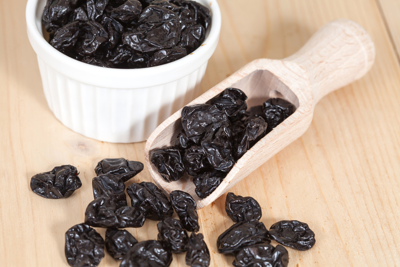 Raisin in wood spoon on the wood background