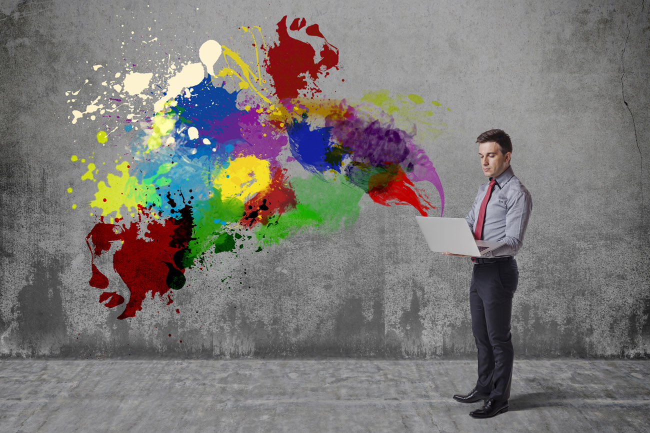 creative business man using laptop against grunge background