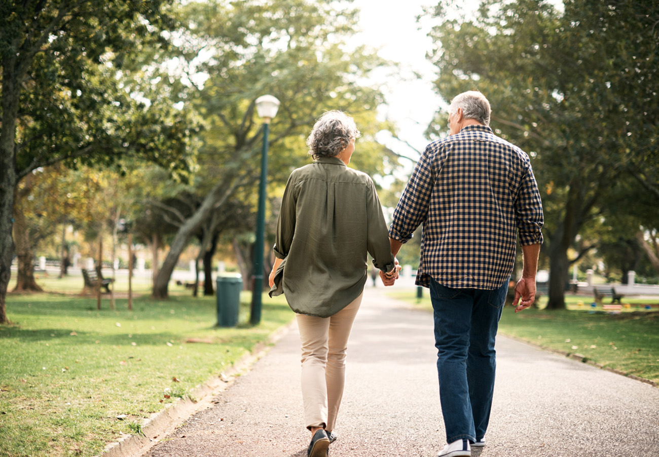 Rearview shot of a senior couple going for a walk in the park