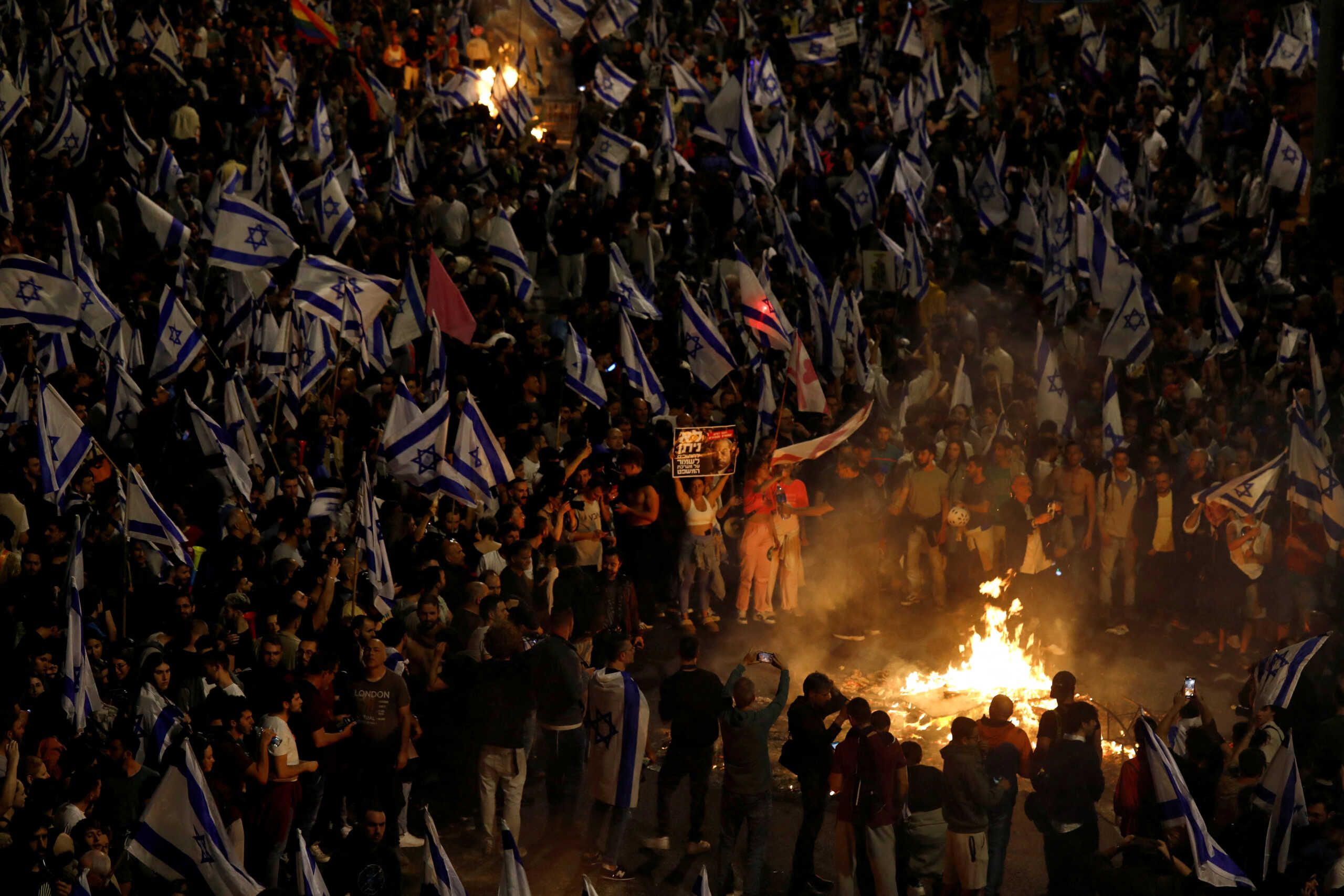 People attend a demonstration after Israeli Prime Minister Benjamin Netanyahu dismissed the defense minister and his nationalist coalition government presses on with its judicial overhaul, in Tel Aviv, Israel, March 26, 2023. REUTERS