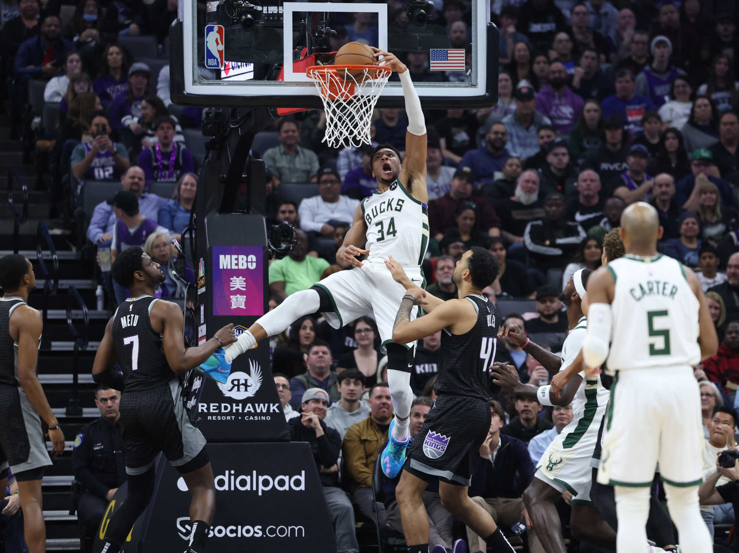 Mar 13, 2023; Sacramento, California, USA; Milwaukee Bucks power forward Giannis Antetokounmpo (34) dunks the ball above Sacramento Kings center Trey Lyles (41) during the first quarter at Golden 1 Center. Mandatory Credit: Kelley L Cox-USA TODAY Sports