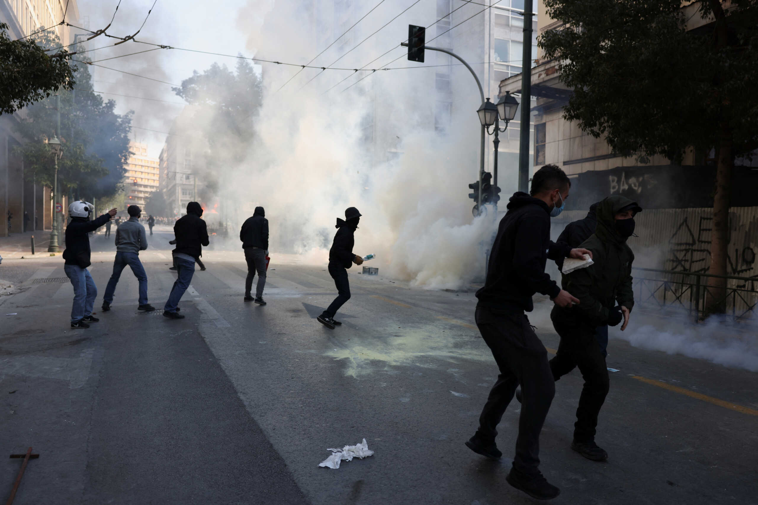 Protesters clash with police during a demonstration following the fatal collision of two trains, near the city of Larissa, in Athens, Greece, March 8, 2023. REUTERS