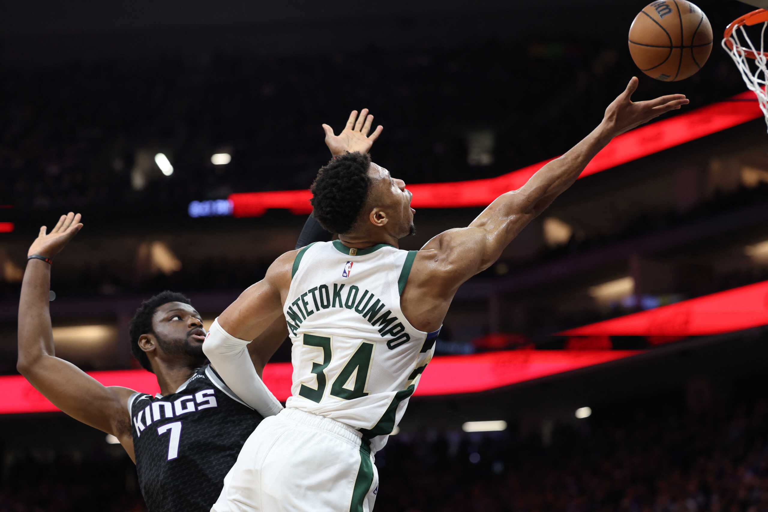 Mar 13, 2023; Sacramento, California, USA; Milwaukee Bucks power forward Giannis Antetokounmpo (34) scores a basket against Sacramento Kings power forward Chimezie Metu (7) during the third quarter at Golden 1 Center. Mandatory Credit: Kelley L Cox-USA TODAY Sports