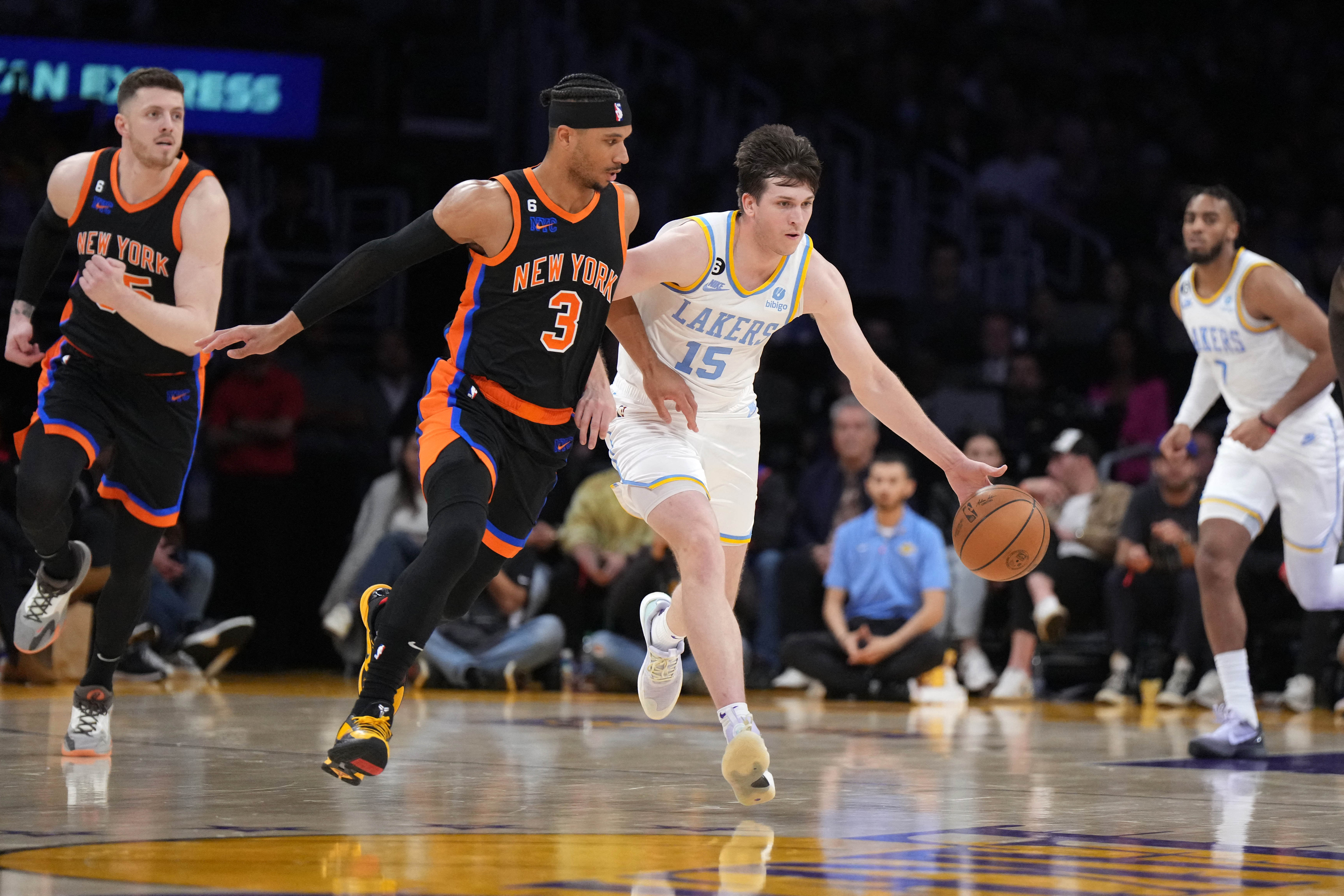 Mar 12, 2023; Los Angeles, California, USA; Los Angeles Lakers guard Austin Reaves (15) dribbles the ball against New York Knicks guard Josh Hart (3) in the second half at Crypto.com Arena. Mandatory Credit: Kirby Lee-USA TODAY Sports