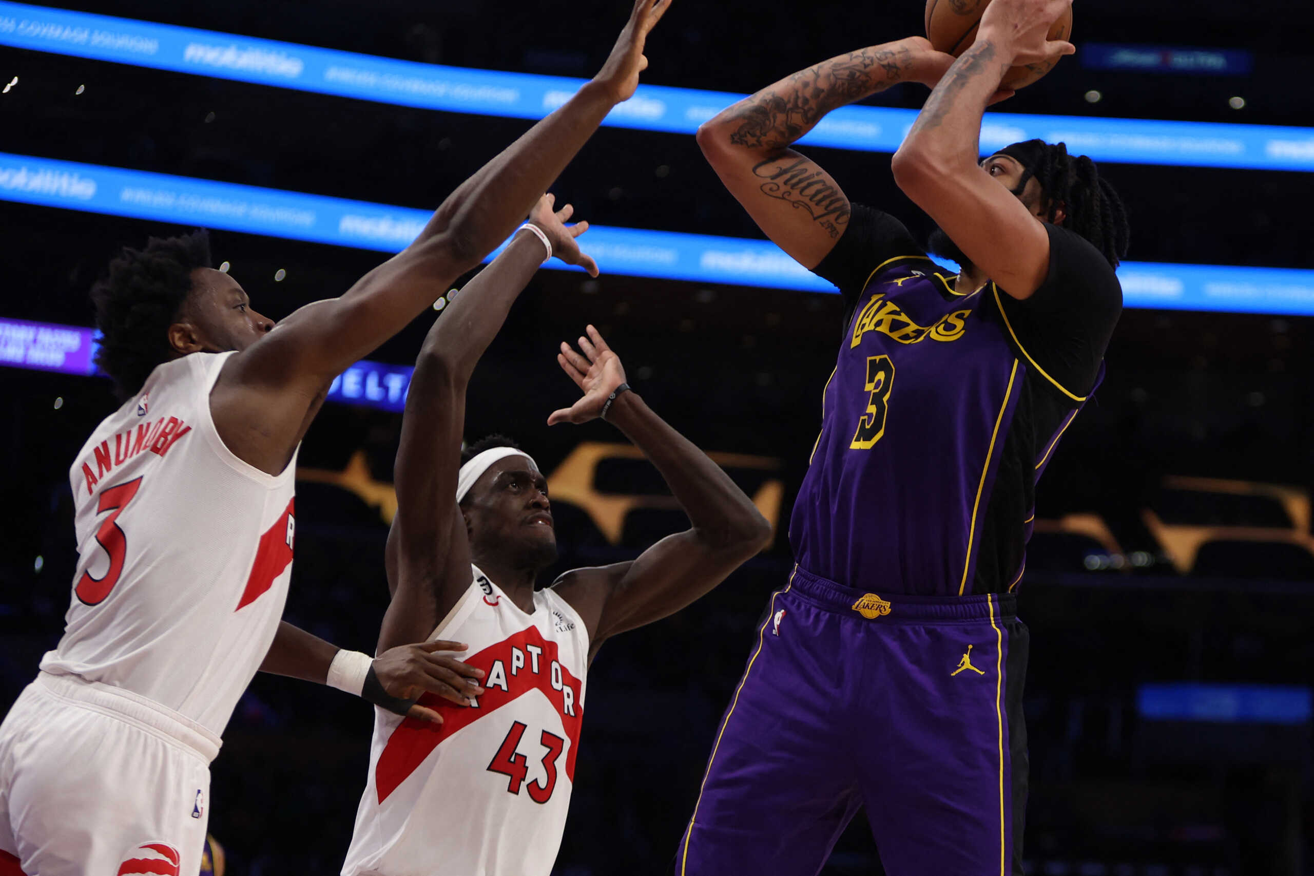 Mar 10, 2023; Los Angeles, California, USA;  Los Angeles Lakers forward Anthony Davis (3) shoots the ball over Toronto Raptors forward O.G. Anunoby (3) and forward Pascal Siakam (43) during the third quarter at Crypto.com Arena. Mandatory Credit: Kiyoshi Mio-USA TODAY Sports