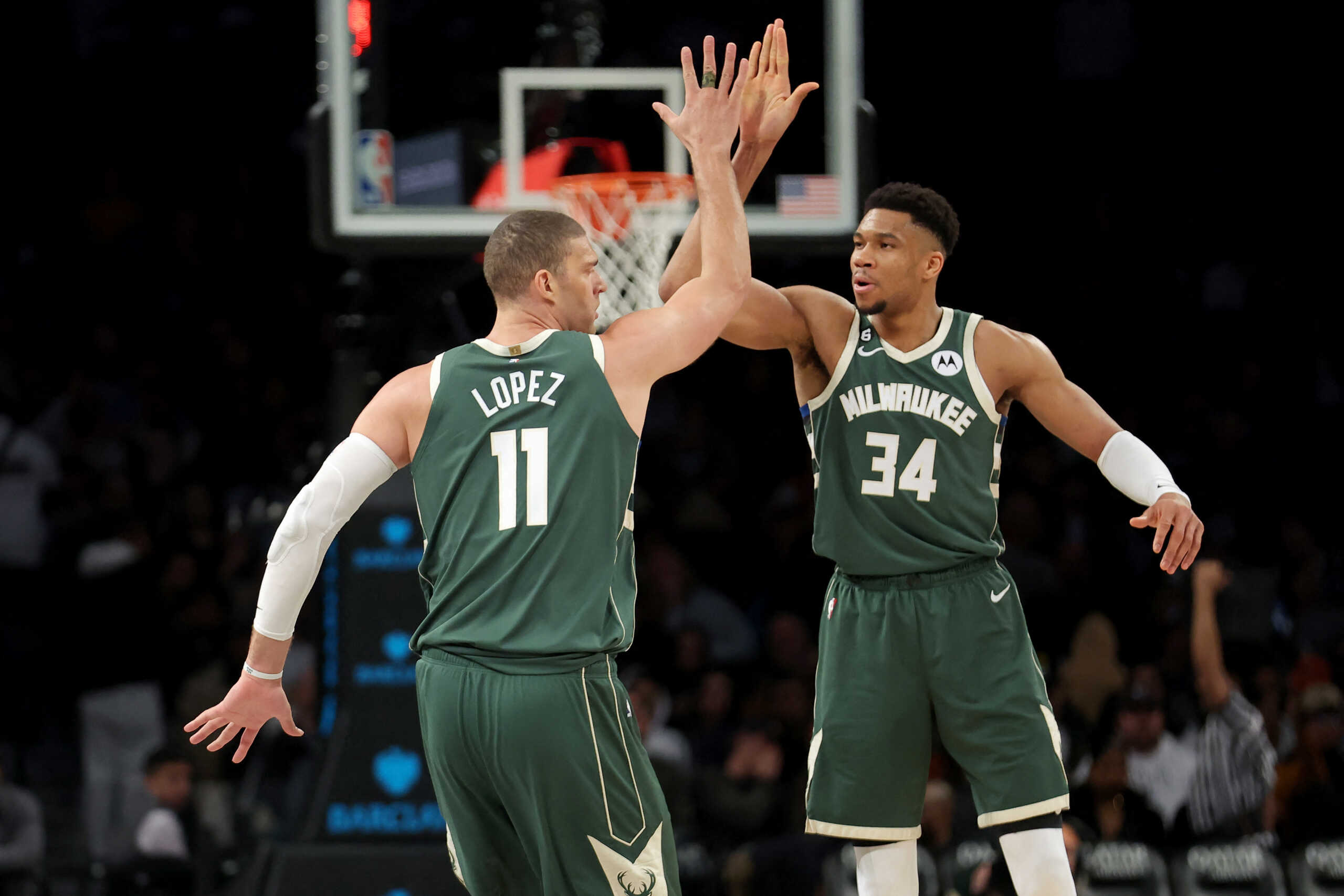 Feb 28, 2023; Brooklyn, New York, USA; Milwaukee Bucks center Brook Lopez (11) high fives forward Giannis Antetokounmpo (34) during the third quarter against the Brooklyn Nets at Barclays Center. Mandatory Credit: Brad Penner-USA TODAY Sports