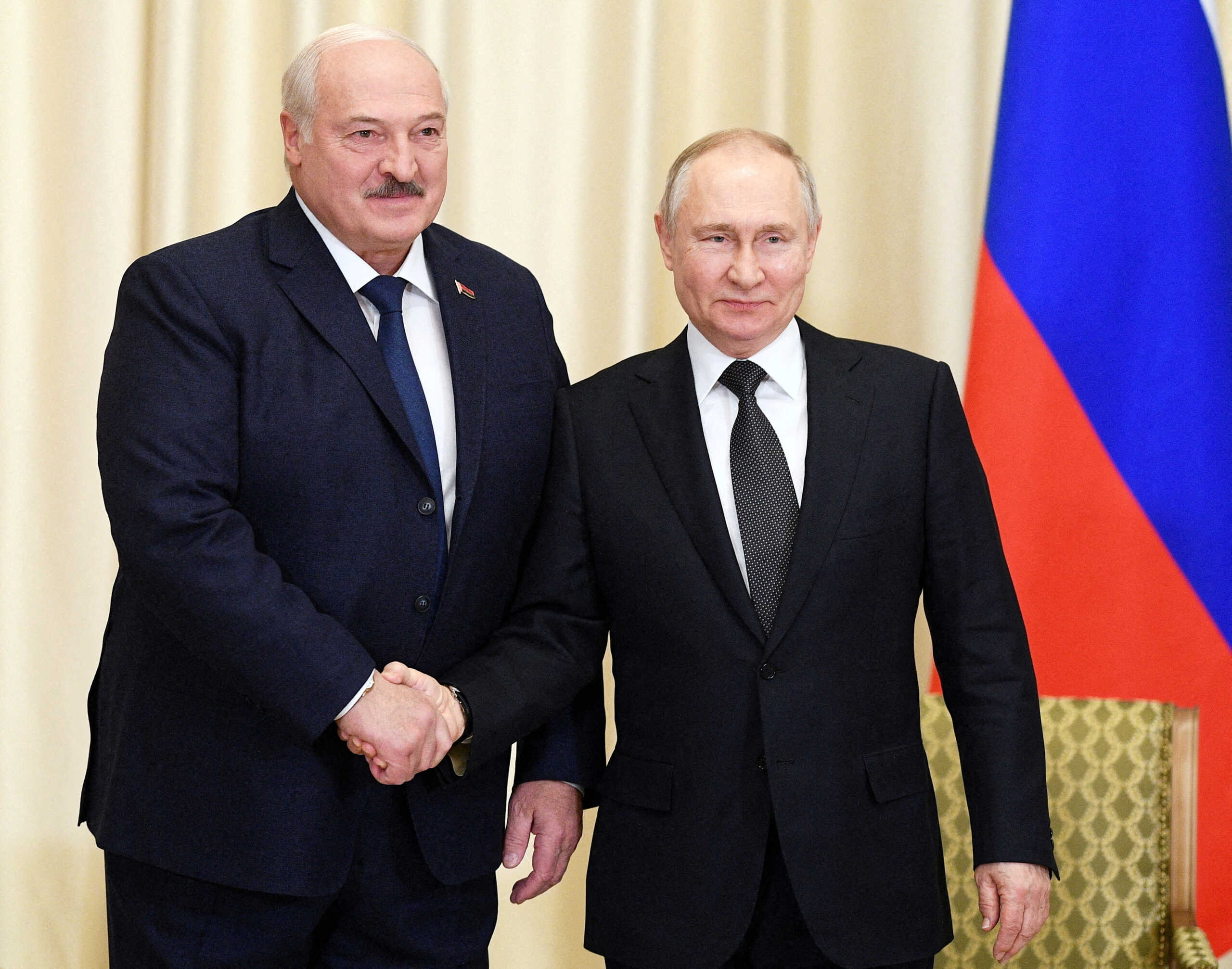 FILE PHOTO: Russian President Vladimir Putin shakes hands with Belarusian President Alexander Lukashenko during a meeting at the Novo-Ogaryovo state residence outside Moscow, Russia February 17, 2023. Sputnik