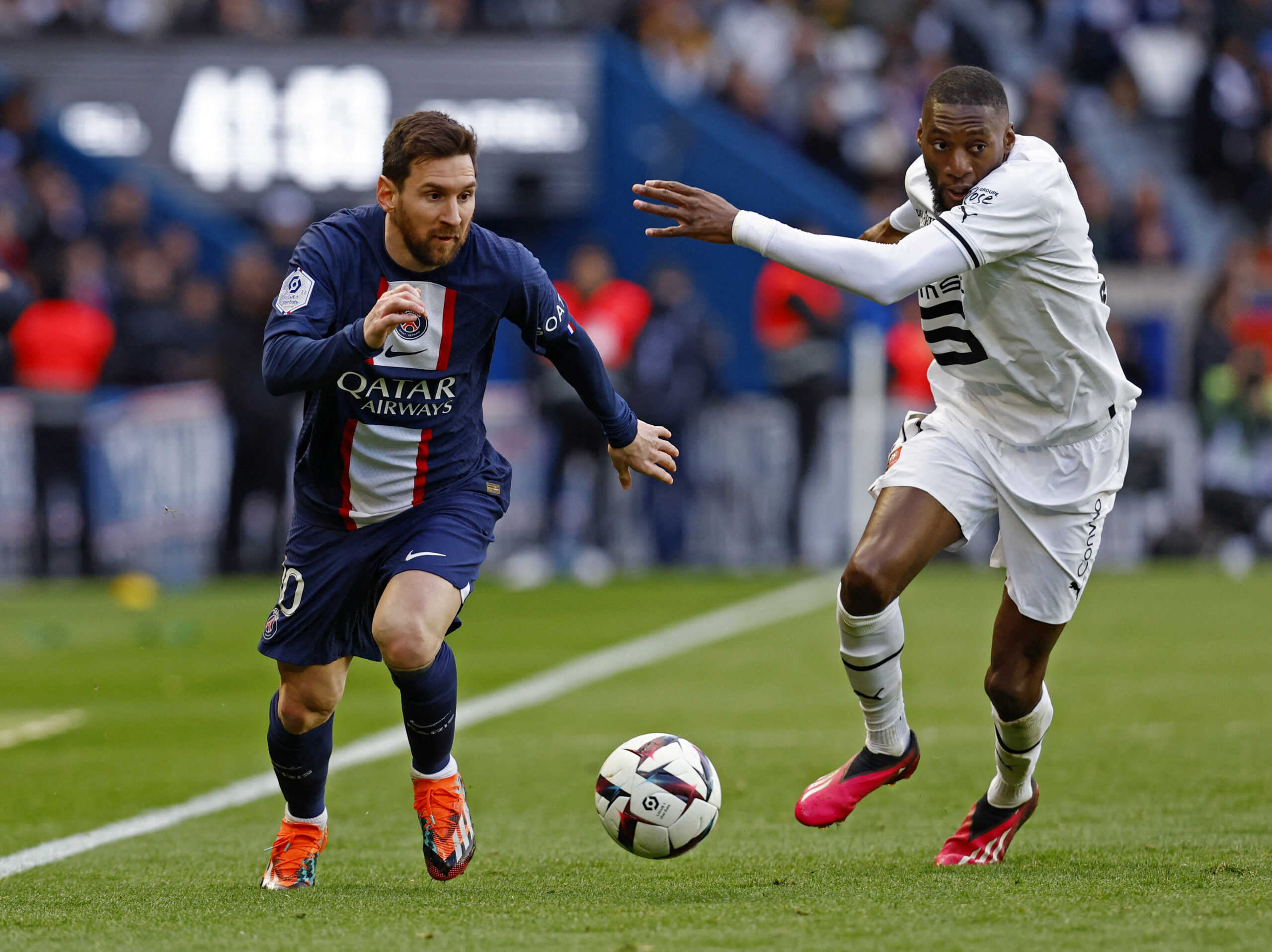Soccer Football - Ligue 1 - Paris St Germain v Stade Rennes - Parc des Princes, Paris, France - March 19, 2023 Paris St Germain's Lionel Messi in action with Stade Rennes' Karl Toko Ekambi REUTERS