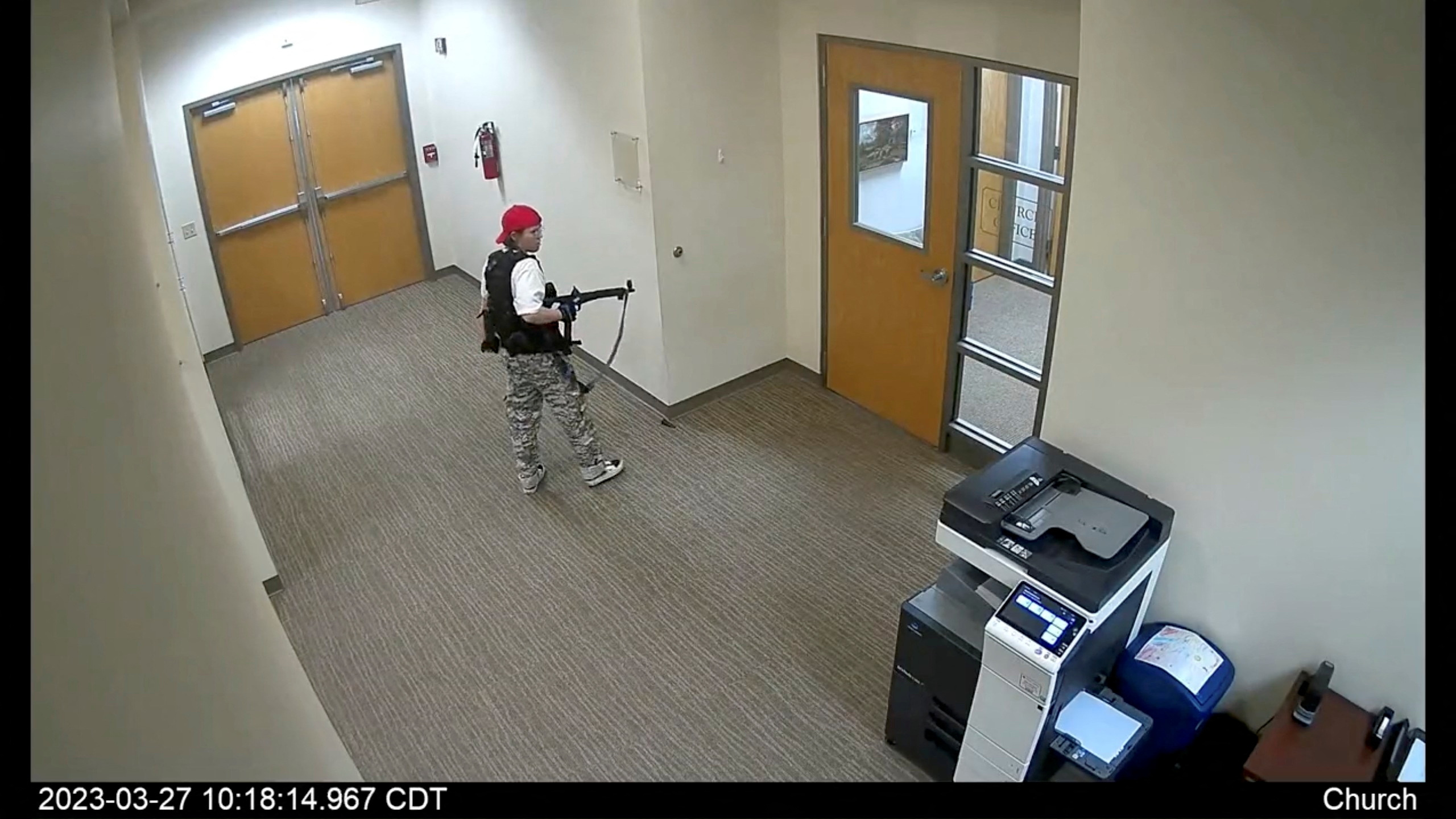 A still image from surveillance video shows what the Metropolitan Nashville Police Department describe as mass shooting suspect Audrey Elizabeth Hale, 28, entering The Covenant School carrying weapons in Nashville, Tennessee, U.S. March 27, 2023.  Metropolitan Nashville Police Department