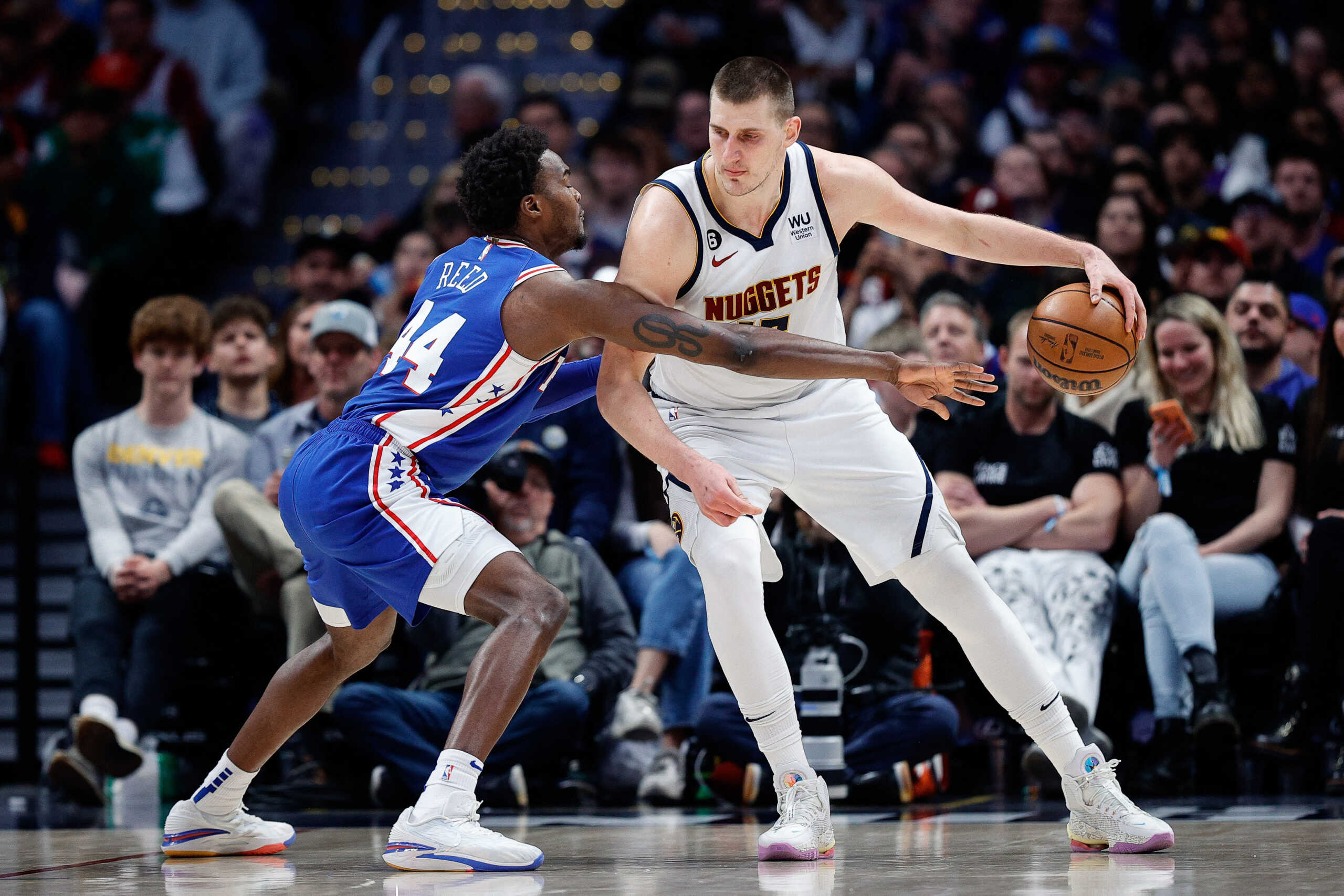 Mar 27, 2023; Denver, Colorado, USA; Denver Nuggets center Nikola Jokic (15) controls the ball as Philadelphia 76ers forward Paul Reed (44) guards in the third quarter at Ball Arena. Mandatory Credit: Isaiah J. Downing-USA TODAY Sports