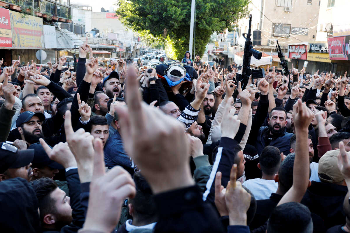 SENSITIVE MATERIAL. THIS IMAGE MAY OFFEND OR DISTURB Mourners gesture as they carry the body of a Palestinian who was killed in Jenin in the Israeli-occupied West Bank, March 16,2023. REUTERS