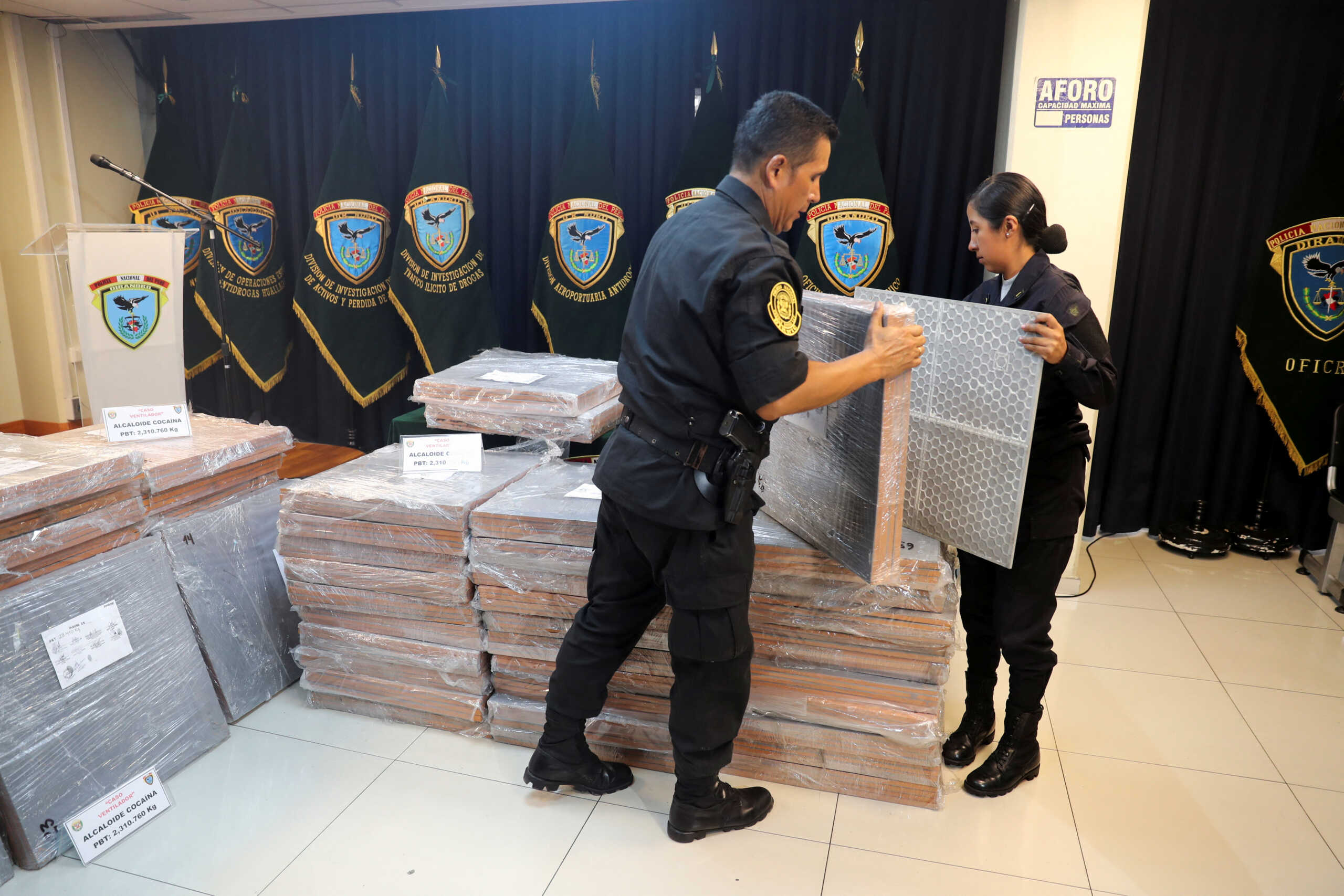 Members of the Peruvian National Police carry drug camouflaged in majolicas, which was seized in an operation at the Callao Port Terminal, in Lima, Peru March 27, 2023. REUTERS
