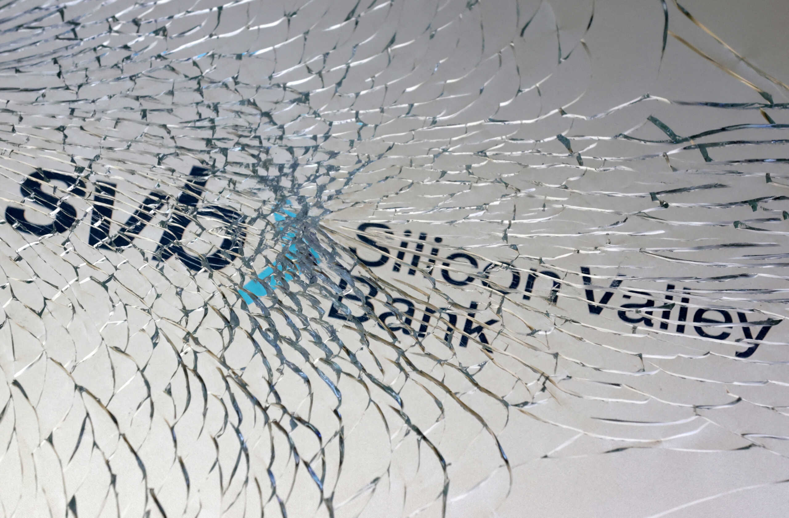 FILE PHOTO: SVB (Silicon Valley Bank) logo is seen through broken glass in this illustration taken March 10, 2023. REUTERS