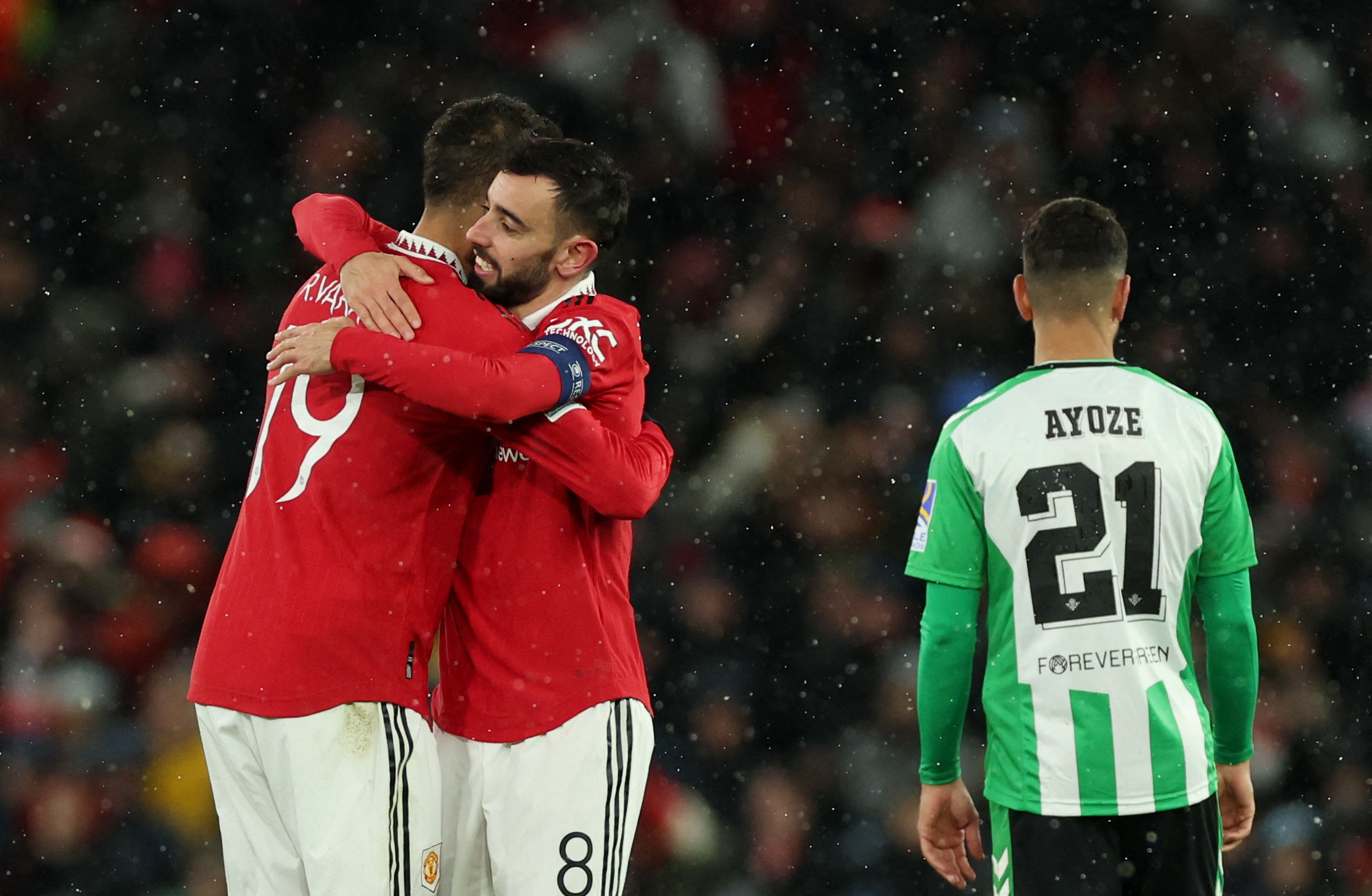 Soccer Football - Europa League - Round of 16 - First Leg - Manchester United v Real Betis - Old Trafford, Manchester, Britain - March 9, 2023 Manchester United's Bruno Fernandes celebrates scoring their third goal with Raphael Varane REUTERS