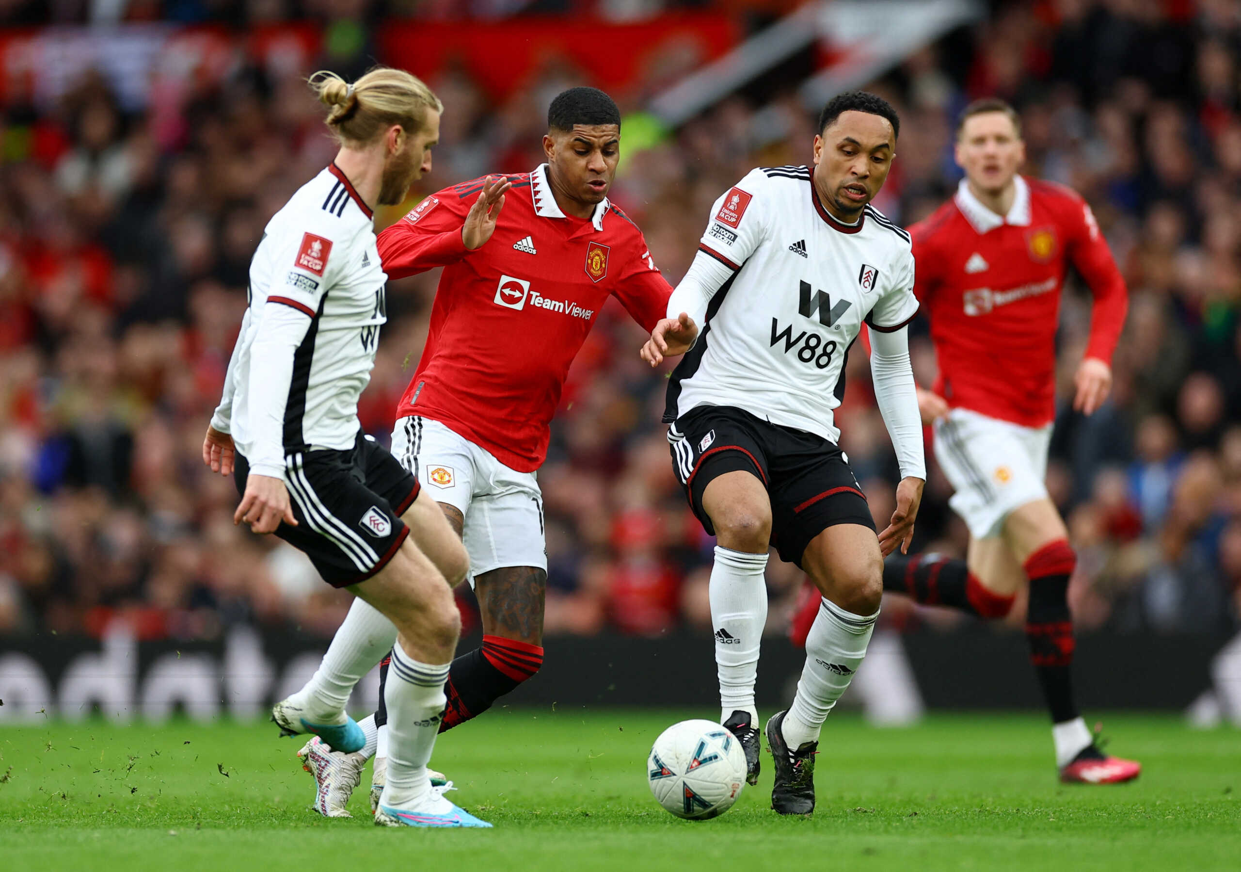 Soccer Football - FA Cup - Quarter-Final - Manchester United v Fulham - Old Trafford, Manchester, Britain - March 19, 2023 Manchester United's Marcus Rashford in action with Fulham's Kenny Tete and Tim Ream REUTERS