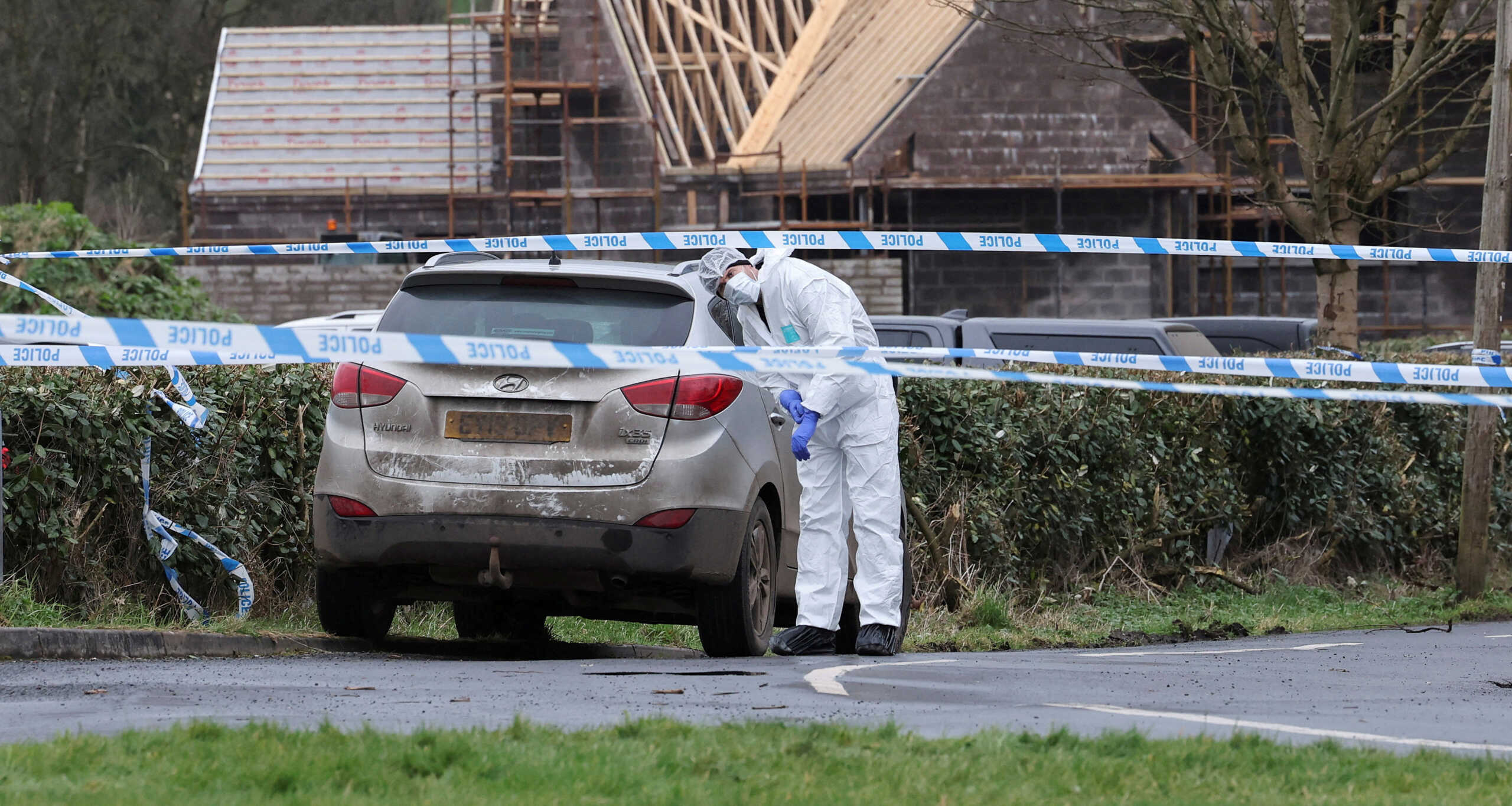FILE PHOTO: A forensic officer from Police Service of Northern Ireland (PSNI) works at the scene of the Youth Sport Omagh sports complex on Killyclogher Road area, where off-duty PSNI Detective Chief Inspector John Caldwell was shot, in Omagh, Northern Ireland February 23, 2023. REUTERS