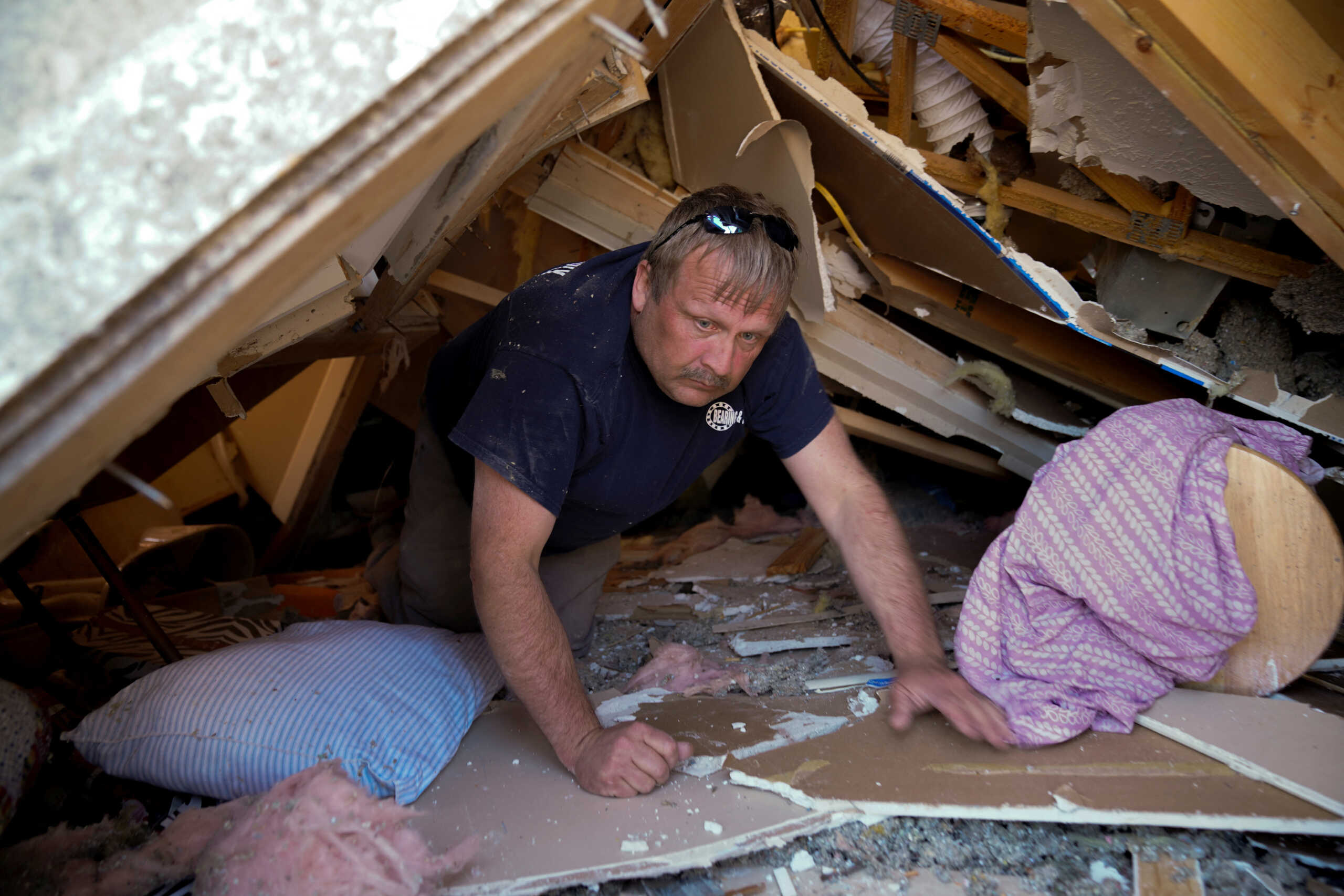 Steve Headley, 51, crawled through the wreckage of his tenants' home to help retrieve their belongings in the aftermath of a tornado, after a monster storm system tore through the South and Midwest on Friday, in Wynne, Arkansas, U.S. April 1, 2023. Steve owns 45 properties in the area, 17 of which have been fully destroyed and several more severely damaged. REUTERS