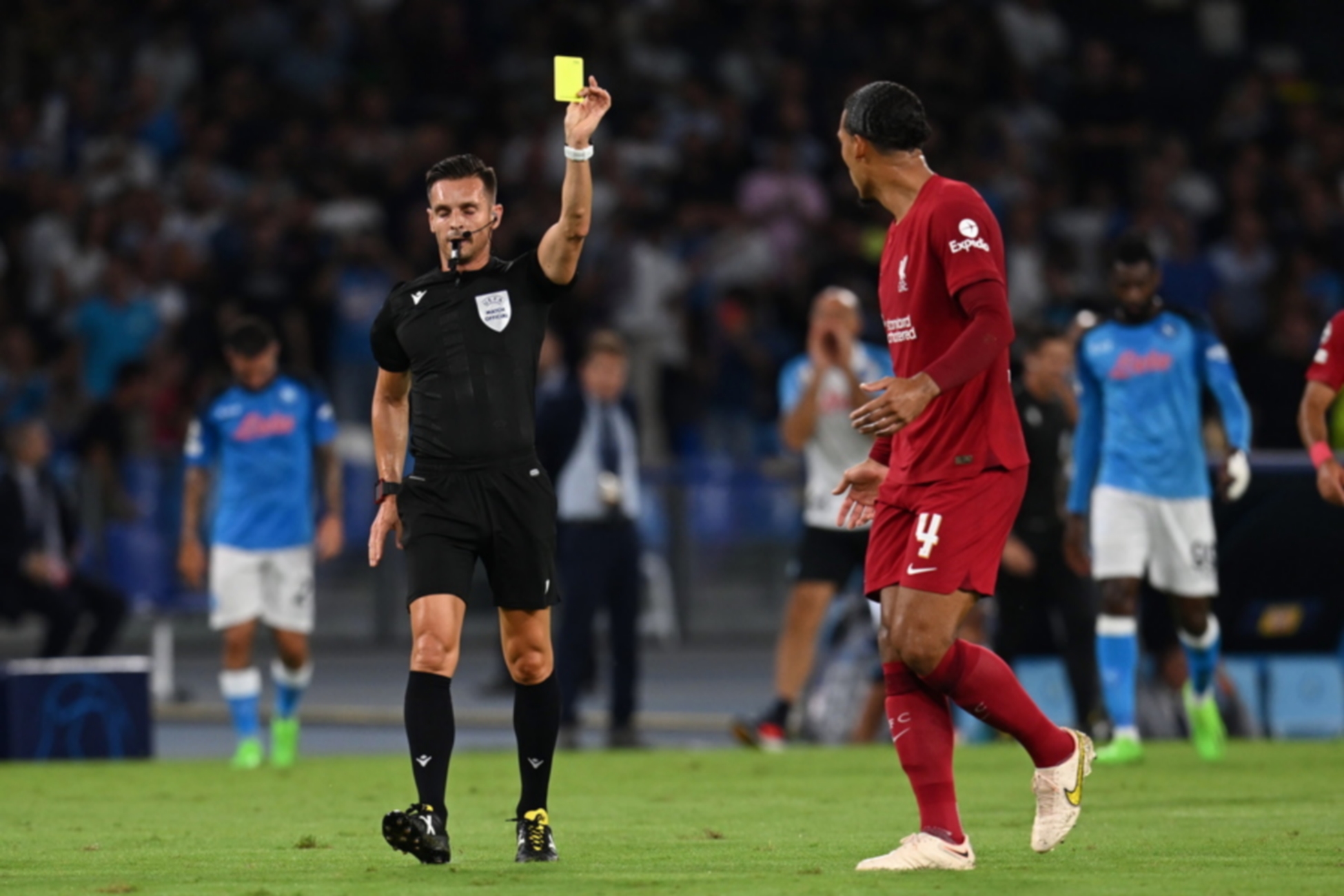 epa10168543 Referee Carlos del Cerro Grande shows the yellow card to Liverpool’s defender Virgil van Dijk during the UEFA Champions League group A soccer match between SSC Napoli and Liverpool FC at the Diego Armando Maradona stadium in Naples, Italy, 07 September 2022.  EPA