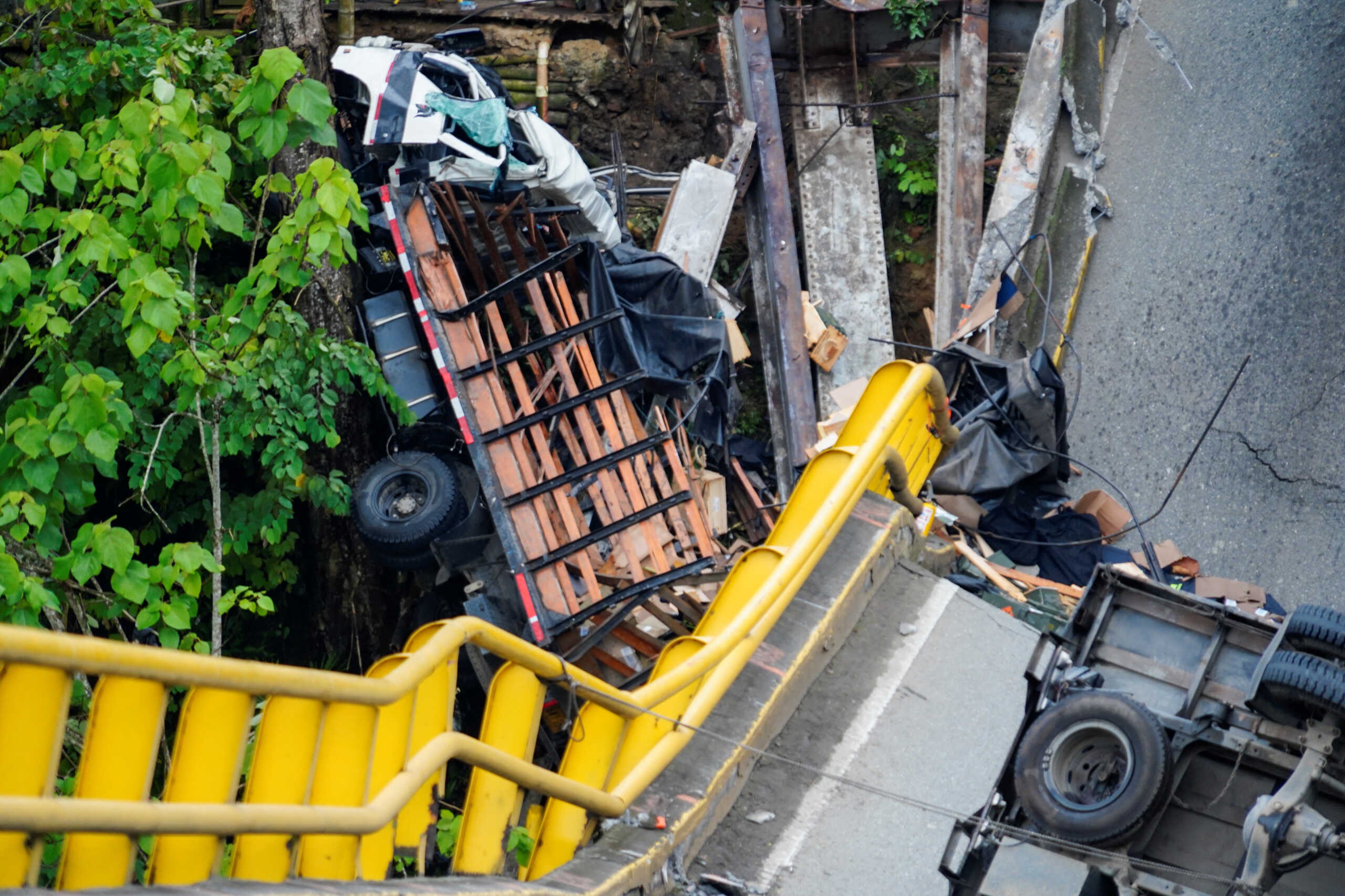 Cars that fell after a vehicular bridge collapsed are seen near La Tebaida, Colombia, April 13, 2023. REUTERS