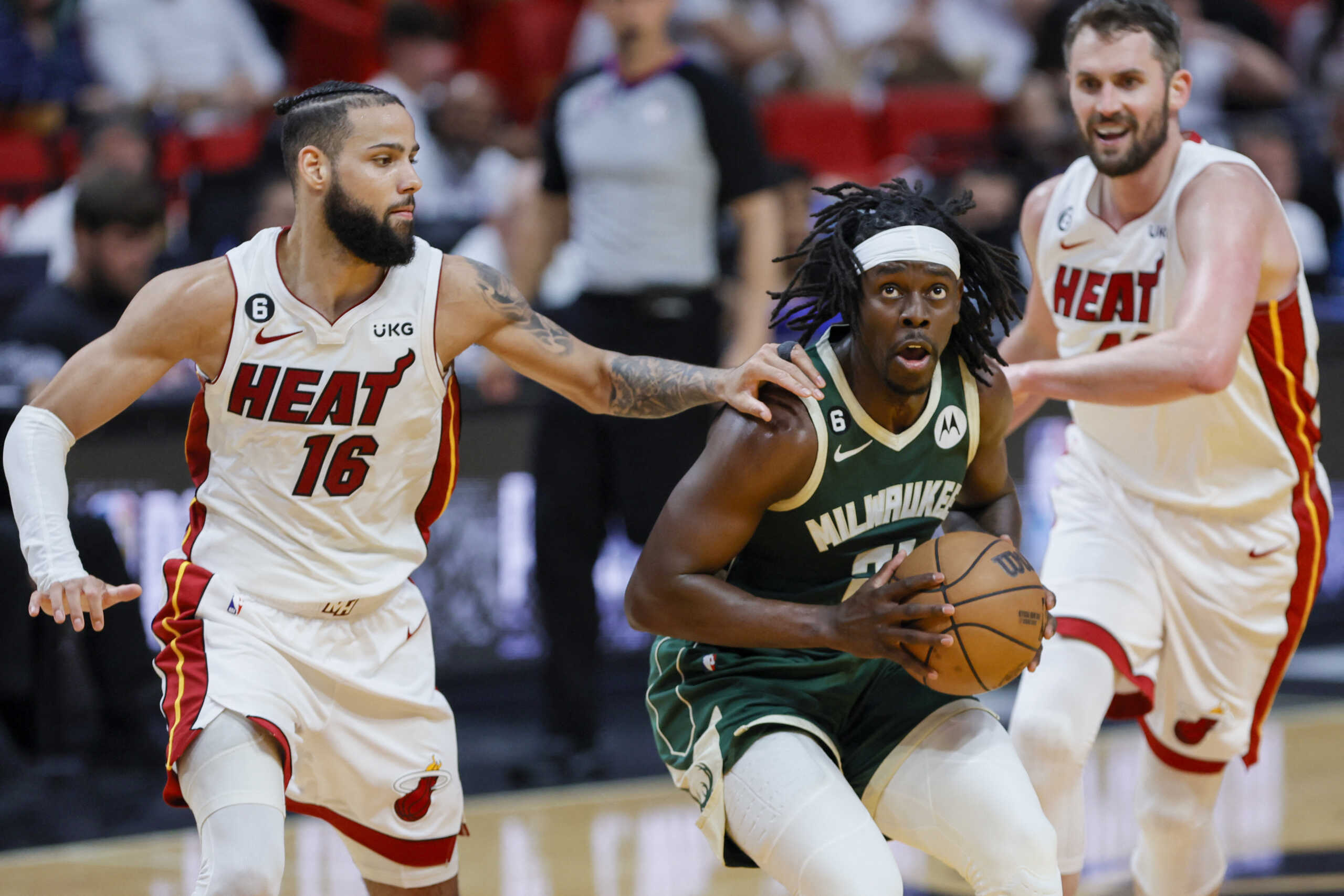 Apr 22, 2023; Miami, Florida, USA; Milwaukee Bucks guard Jrue Holiday (21) drives the basket against Miami Heat forward Caleb Martin (16) in the third quarter during game three of the 2023 NBA Playoffs at Kaseya Center. Mandatory Credit: Sam Navarro-USA TODAY Sports