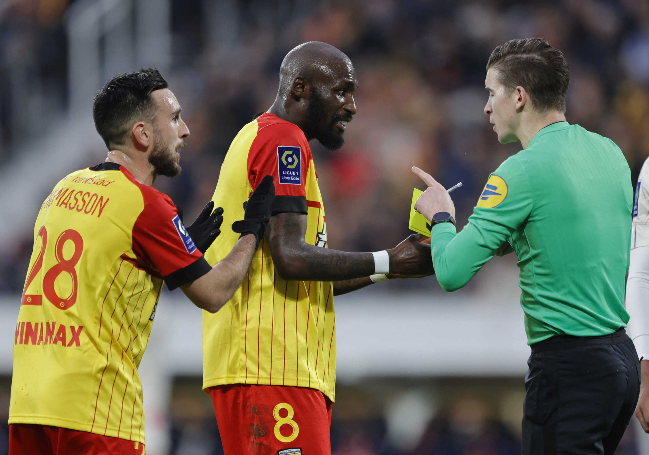 Soccer Football - Ligue 1 - RC Lens v Lille - Stade Bollaert-Delelis, Lens, France - March 4, 2023 RC Lens' Seko Fofana reacts after being shown a yellow card by referee Francois Letexier REUTERS