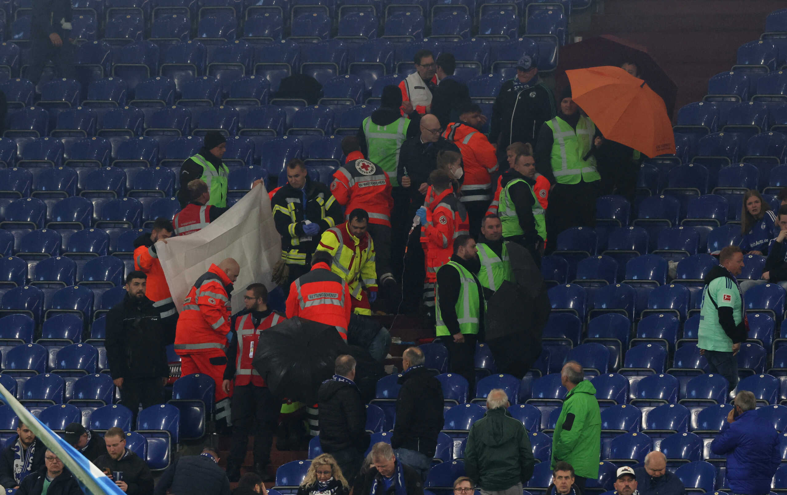 Soccer Football - Bundesliga - Schalke 04 v Bayer Leverkusen - Veltins-Arena, Gelsenkirchen, Germany - April 1, 2023 Medical staff provide assistance to a fan inside the stadium REUTERS