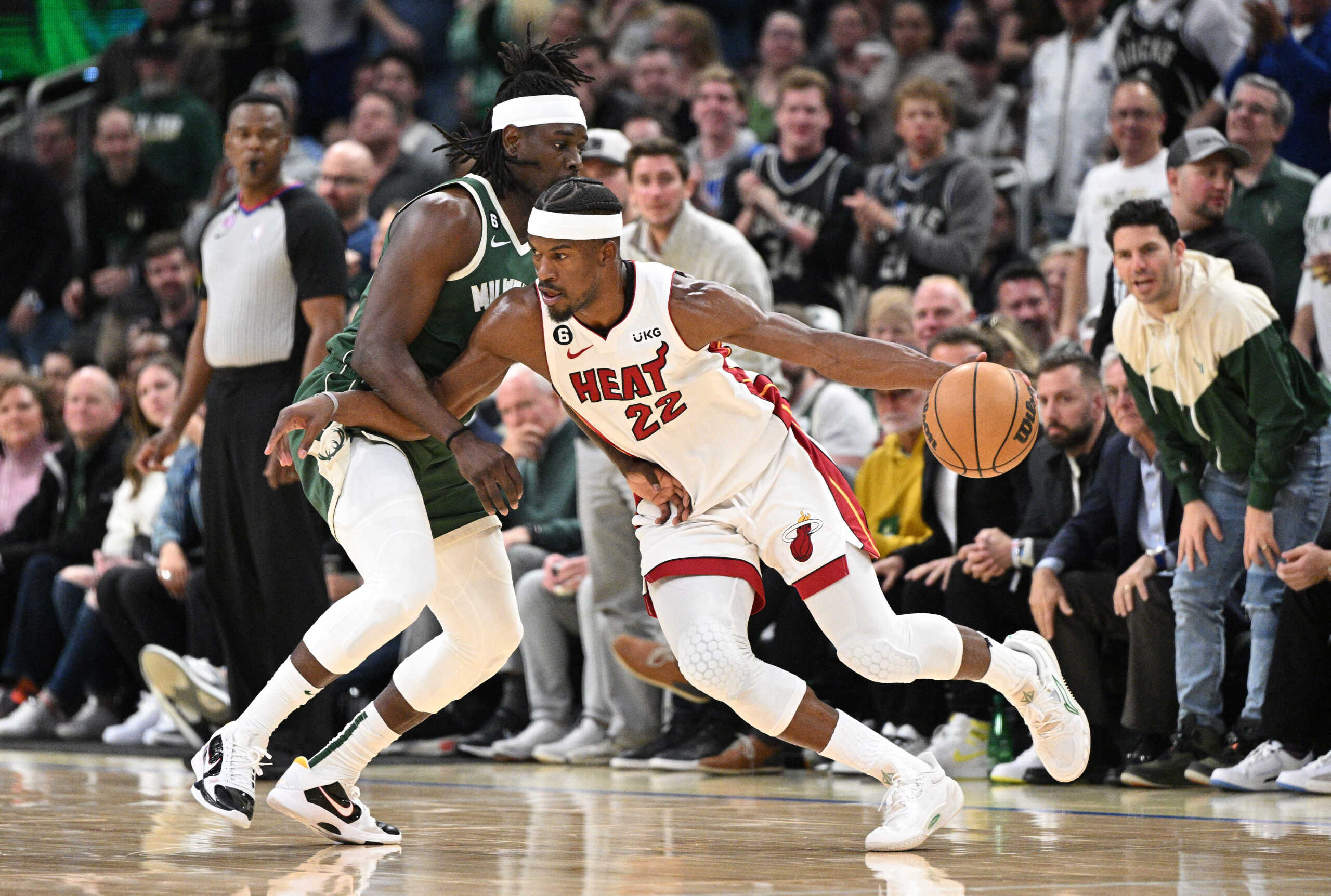 Apr 26, 2023; Milwaukee, Wisconsin, USA; Miami Heat forward Jimmy Butler (22) drives against Milwaukee Bucks guard Jrue Holiday (21) during game five of the 2023 NBA Playoffs at Fiserv Forum. Mandatory Credit: Michael McLoone-USA TODAY Sports