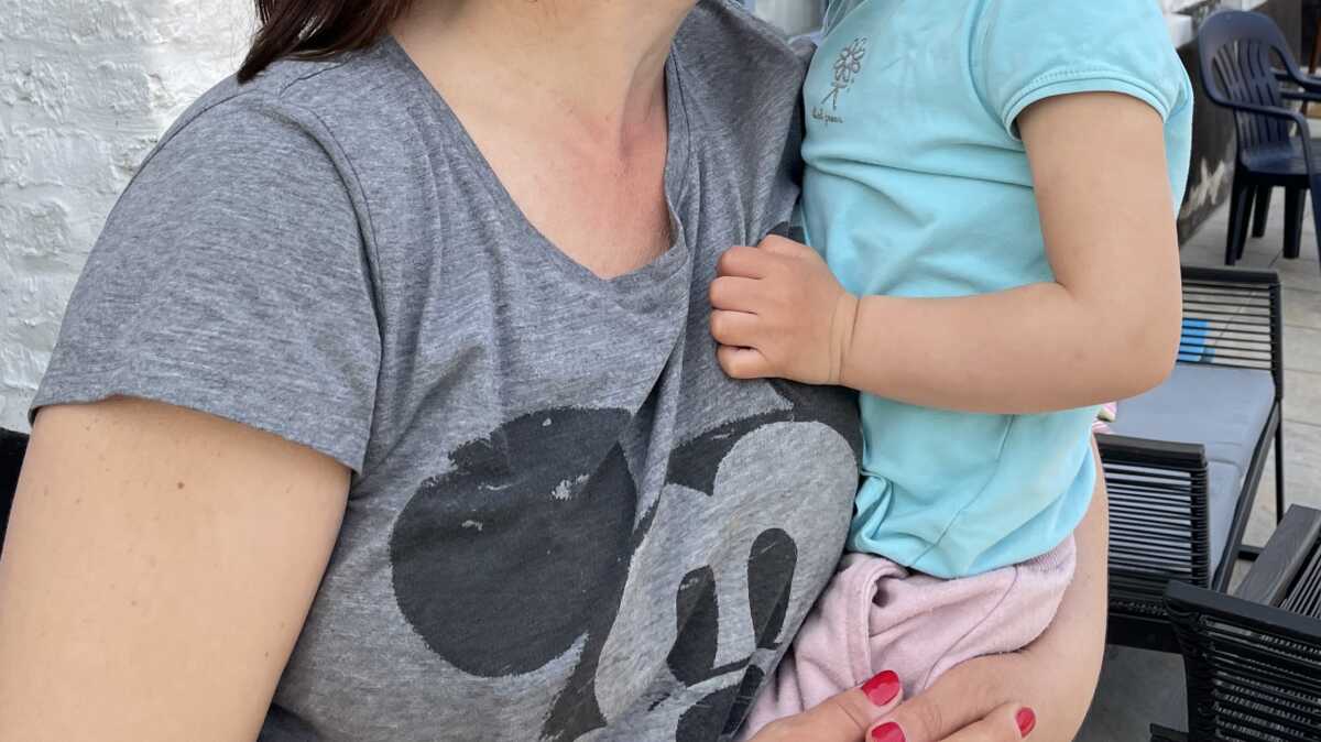 Ukrainian refugee Alina Hanich kisses daughter Alisa, 2, at a farm in Tilques, northern France, where she is living after fleeing their home in the central-eastern city of Dnipro. May 10, 2022. Thomson Reuters Foundation