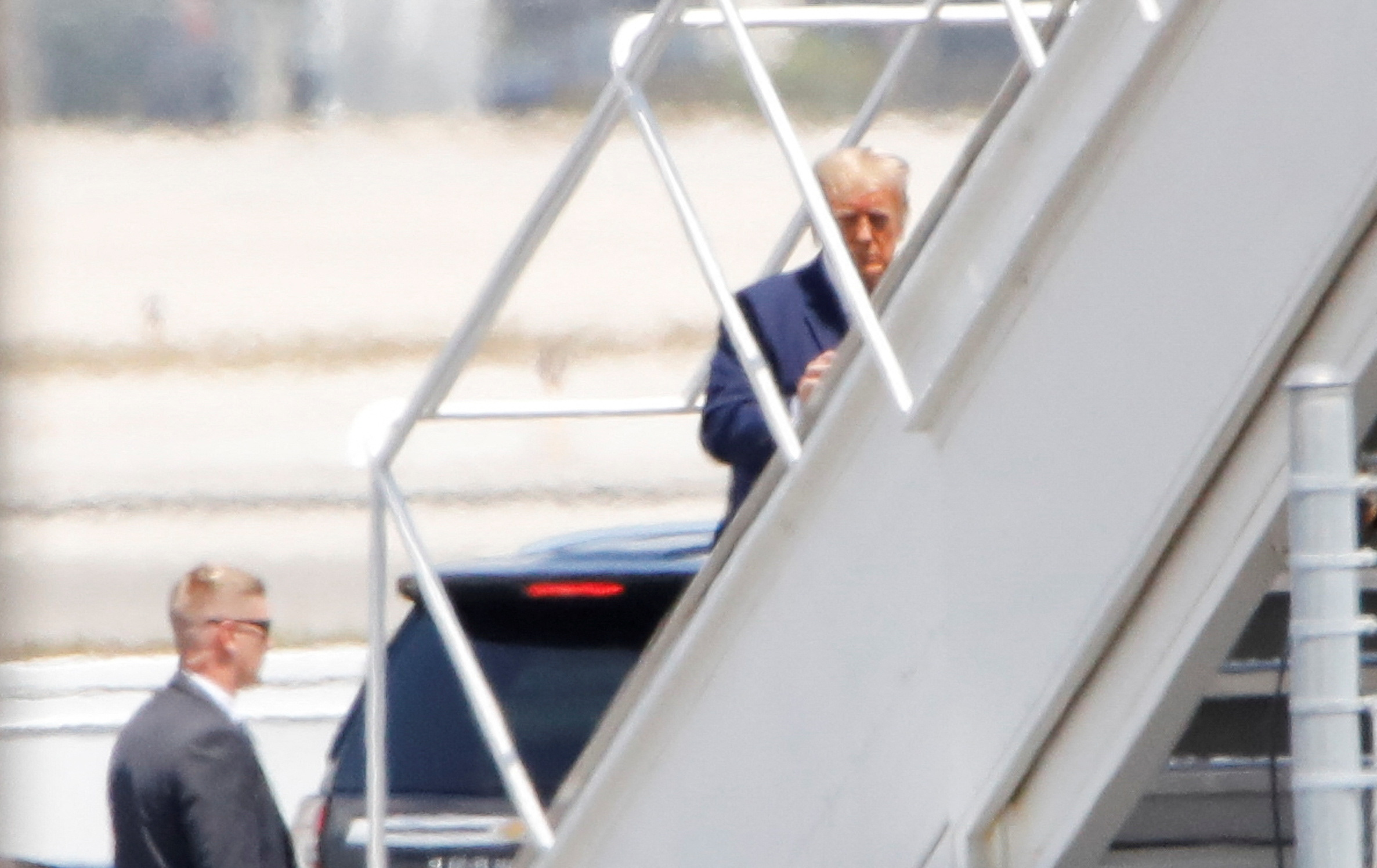 Former U.S. President Donald Trump boards his plane, at the Palm Beach International Airport, after his indictment by a Manhattan grand jury following a probe into hush money paid to porn star Stormy Daniels, in West Palm Beach, Florida, U.S., April 3, 2023. REUTERS