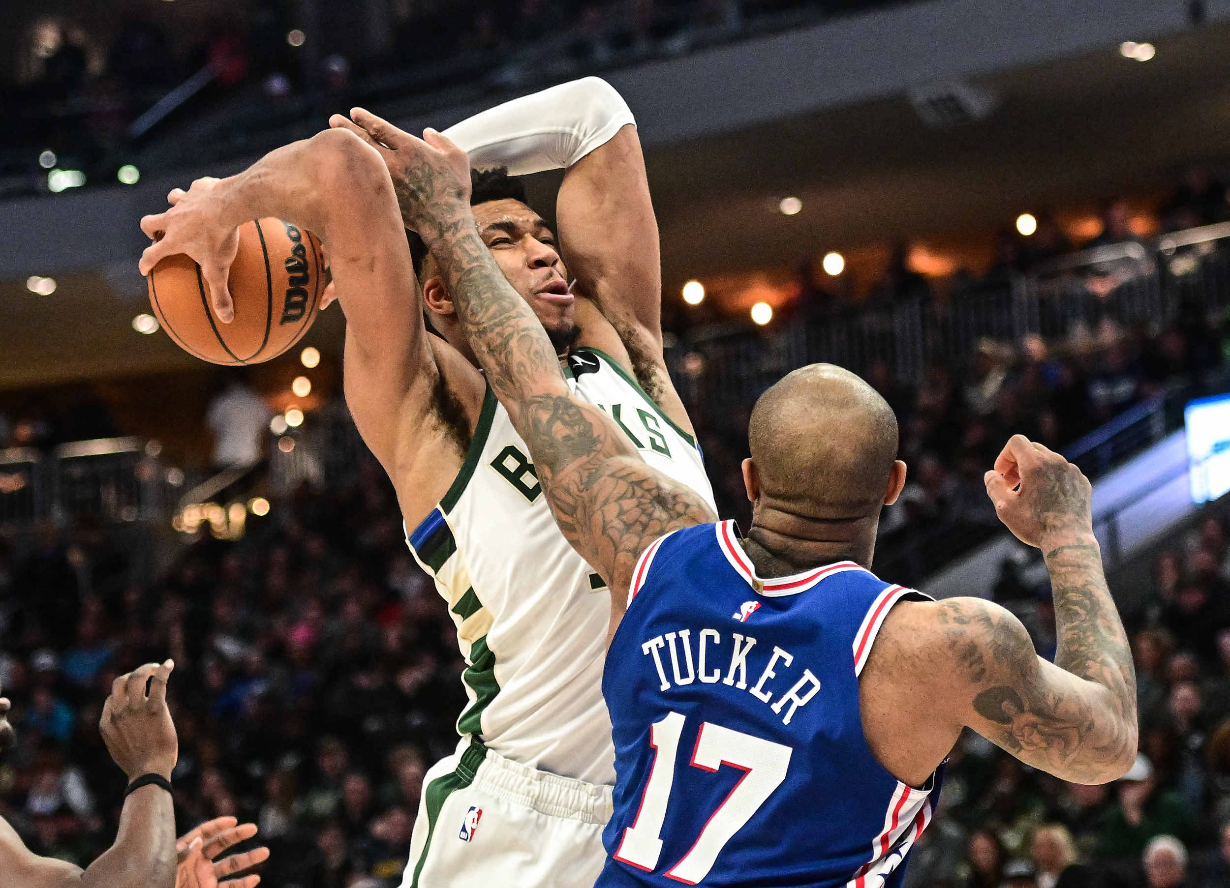 Apr 2, 2023; Milwaukee, Wisconsin, USA; Milwaukee Bucks forward Giannis Antetokounmpo (34) is fouled by Philadelphia 76ers forward P.J. Tucker (17) in the third quarter at Fiserv Forum. Mandatory Credit: Benny Sieu-USA TODAY Sports