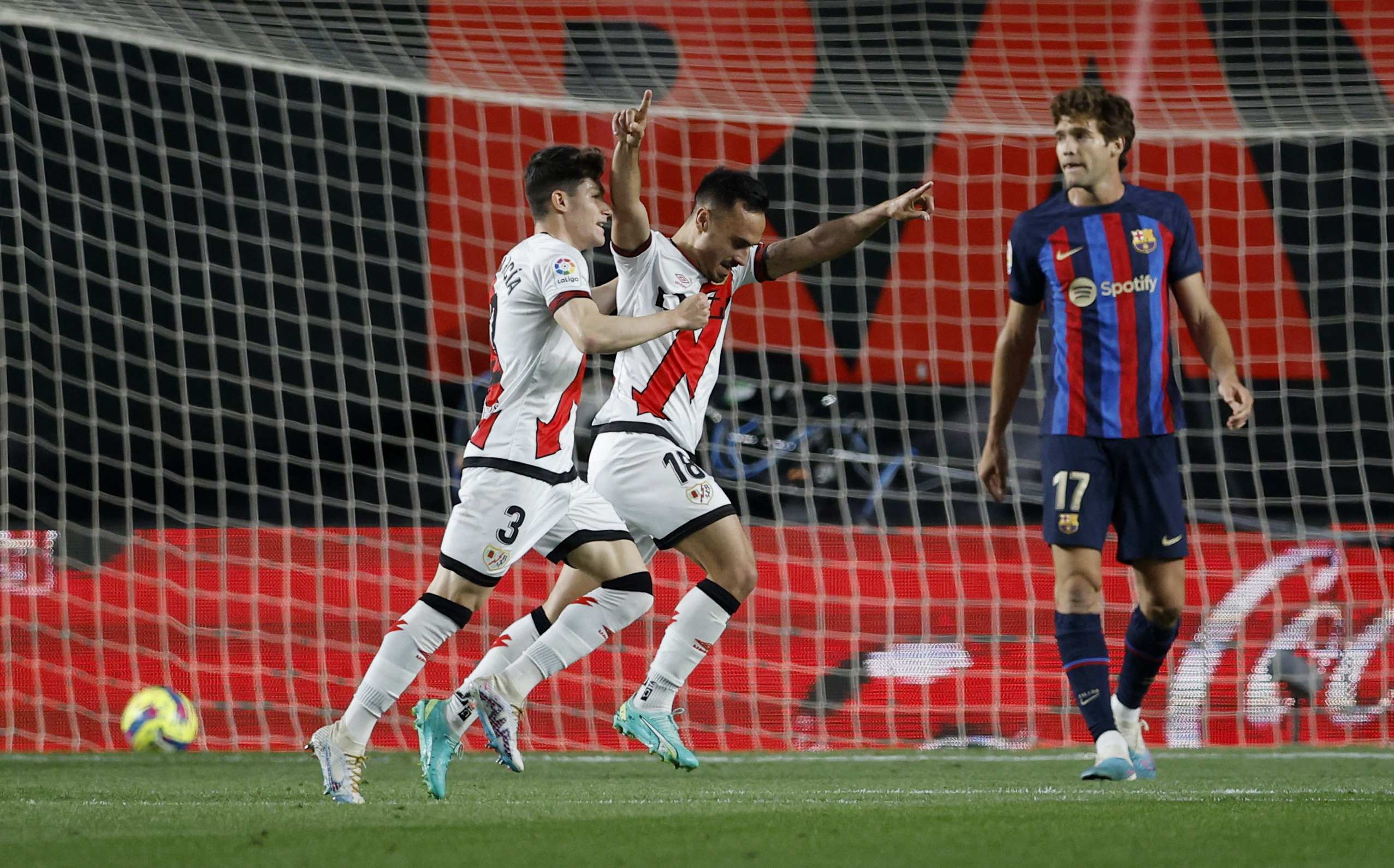 Soccer Football - LaLiga - Rayo Vallecano v FC Barcelona - Campo de Futbol de Vallecas, Madrid, Spain - April 26, 2023 Rayo Vallecano's Alvaro Garcia celebrates scoring their first goal with Fran Garcia as FC Barcelona's Marcos Alonso looks dejected REUTERS