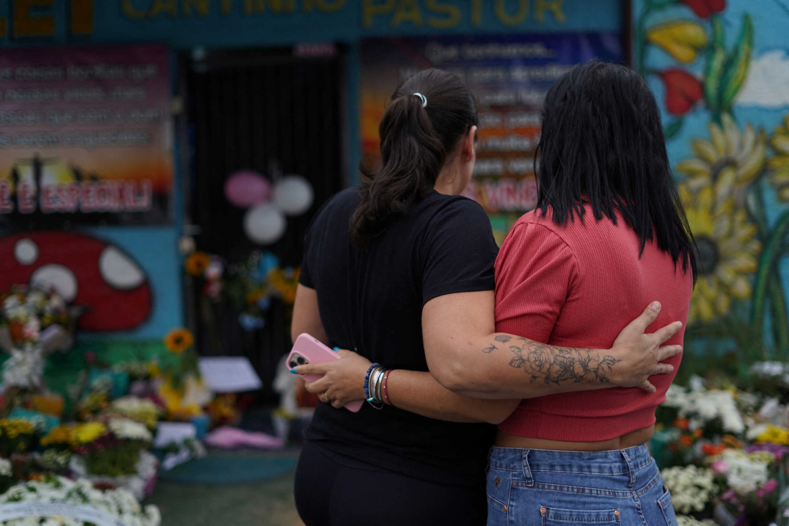 Women embrace during a tribute to victims of a fatal attack at the Cantinho do Bom Pastor daycare center, in Blumenau, in the southern Brazilian state of Santa Catarina, Brazil, April 6, 2023. REUTERS