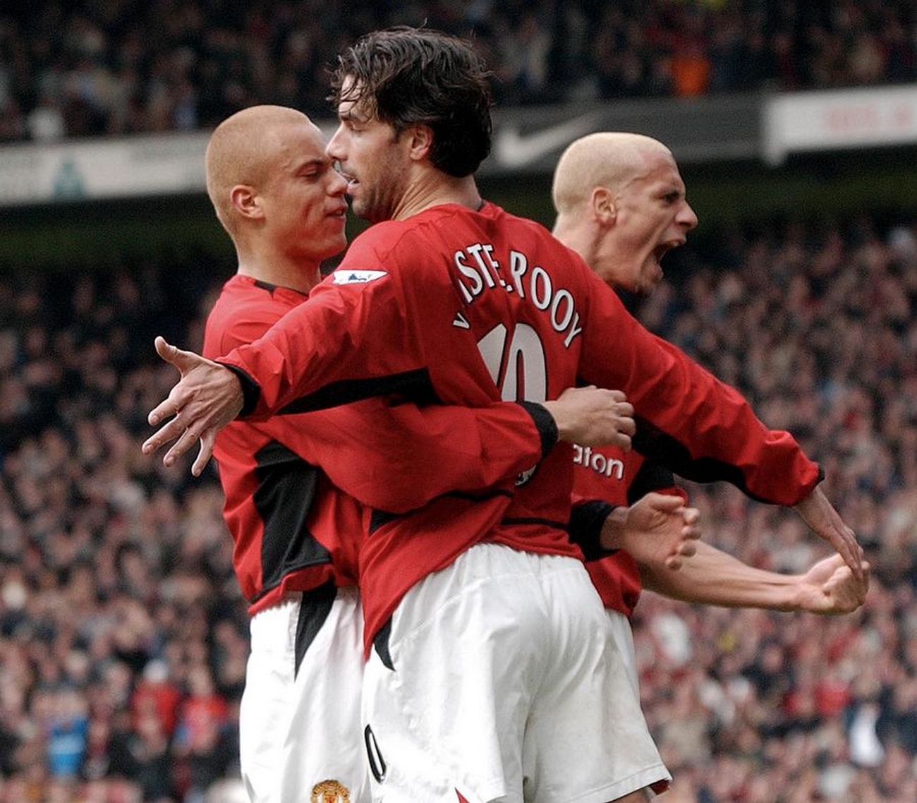 PMB002 - 20030209 - MANCHESTER, UNITED KINGDOM : Manchester United's Ruud Van Nistelrooy (C) celebrates with Wes Brown and Rio Ferdinand (in the background) after scoring the opening goal against Manchester City's during their Premiership Clash at Old Trafford in Manchester 09 February 2003.  
EPA PHOTO EPA