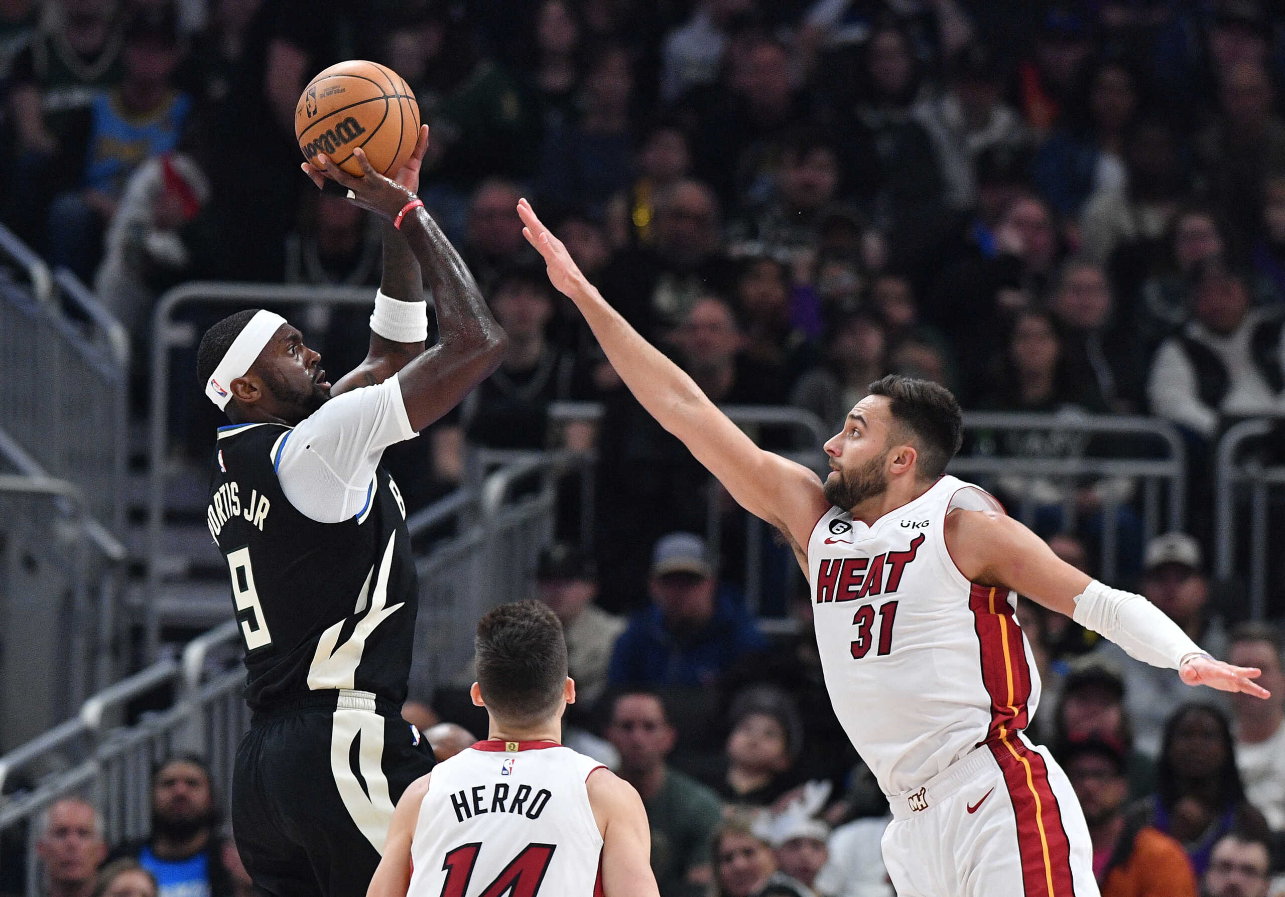 Apr 16, 2023; Milwaukee, Wisconsin, USA; Milwaukee Bucks forward Bobby Portis (9) shoots the ball against Miami Heat guard Max Strus (31) in the first half during game one of the 2023 NBA Playoffs at Fiserv Forum. Mandatory Credit: Michael McLoone-USA TODAY Sports