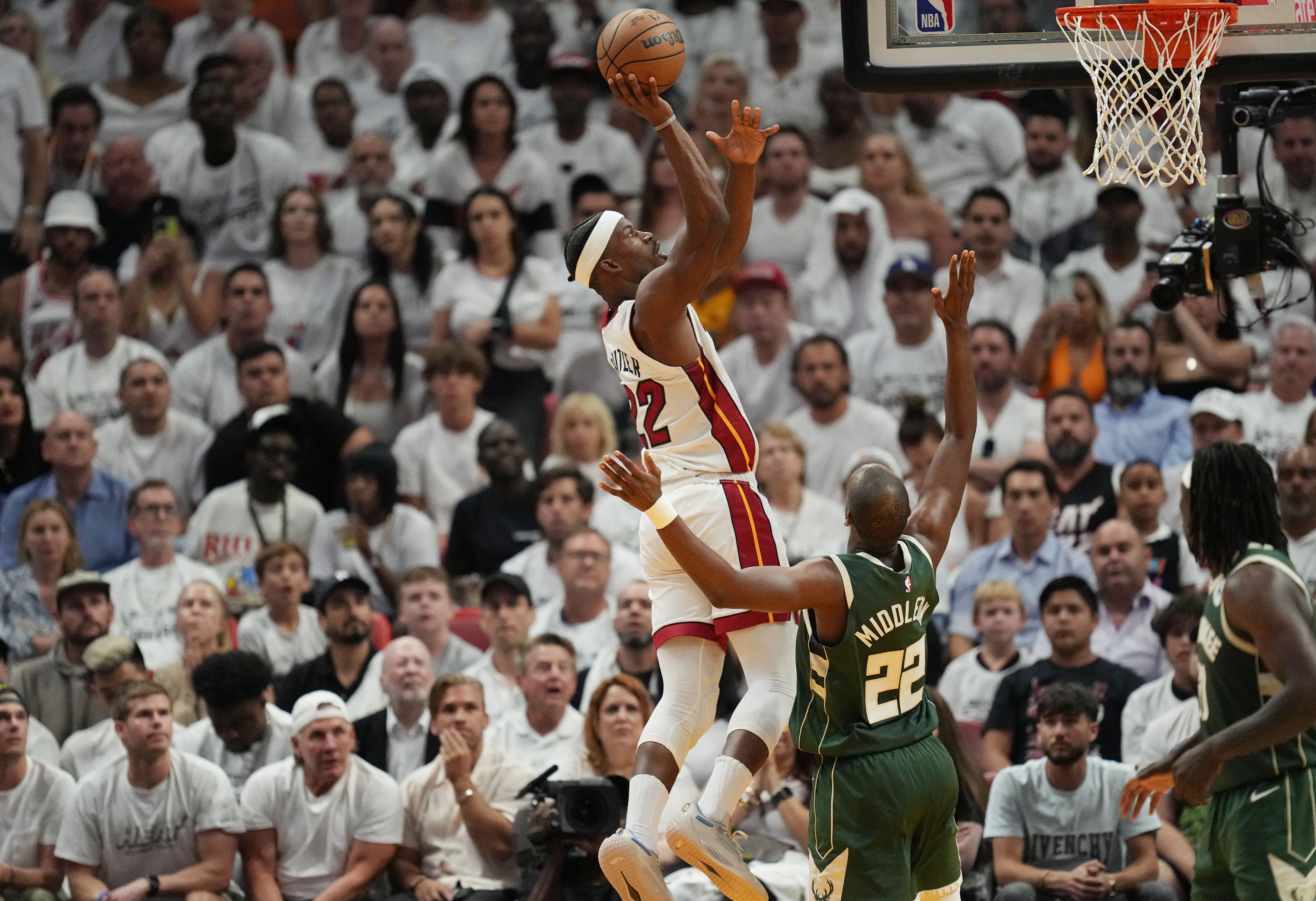 Apr 24, 2023; Miami, Florida, USA; Miami Heat forward Jimmy Butler (22) goes up for a shot over Milwaukee Bucks forward Khris Middleton (22) in the fourth quarter during game four of the 2023 NBA Playoffs at Kaseya Center. Mandatory Credit: Jim Rassol-USA TODAY Sports