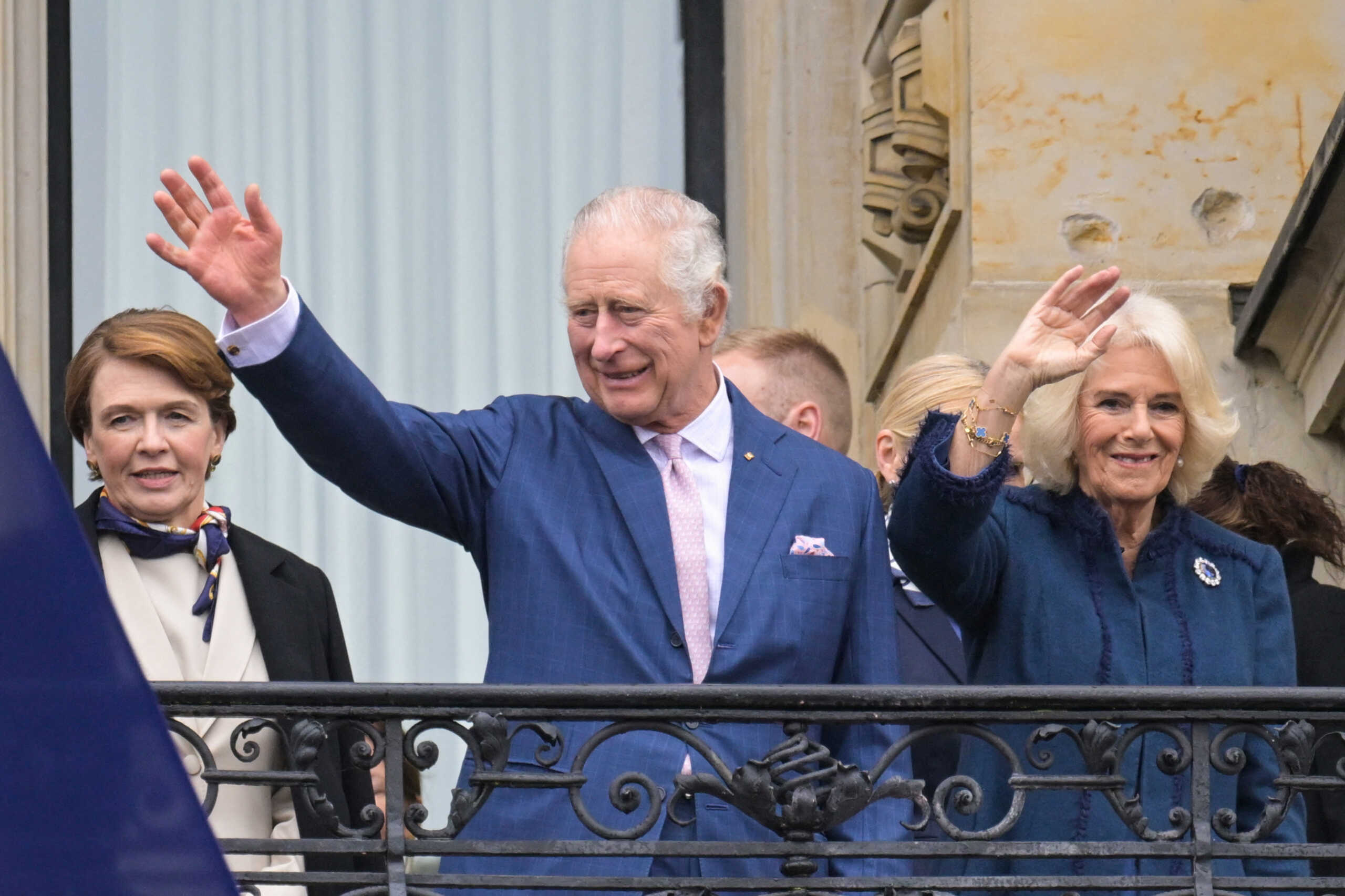 Britain's King Charles and Camilla, the Queen Consort, wave next to German President Frank-Walter Steinmeier's wife Elke Buedenbender, as the visit the town hall to meet members of the public in Hamburg, Germany, March 31, 2023. REUTERS