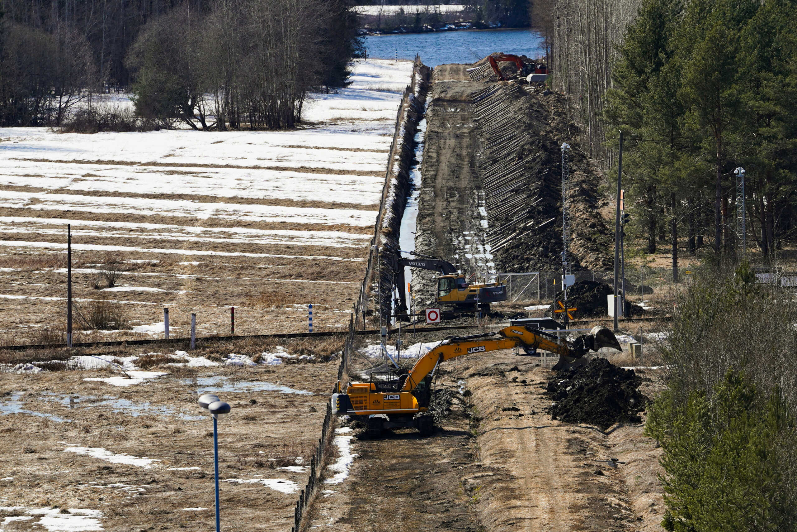 Excavators dig sand near border fence with Russia in Pelkola, Finland April 14, 2023. REUTERS