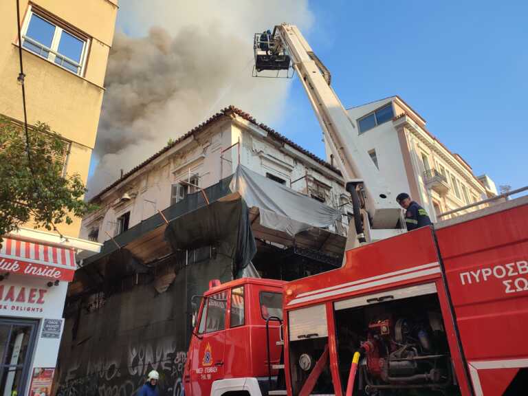 Φόβοι για κατάρρευση τμήματος του κτηρίου που καίγεται στην Αιόλου - Πέφτουν κομμάτια του στο έδαφος
