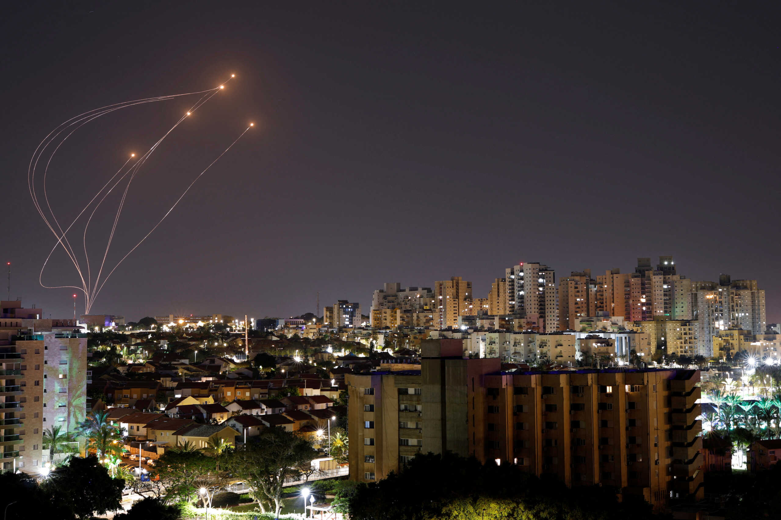 Streaks of light are seen as Israel's Iron Dome anti-missile system intercept rockets launched from the Gaza Strip, as seen from Ashkelon, April 7, 2023.  REUTERS